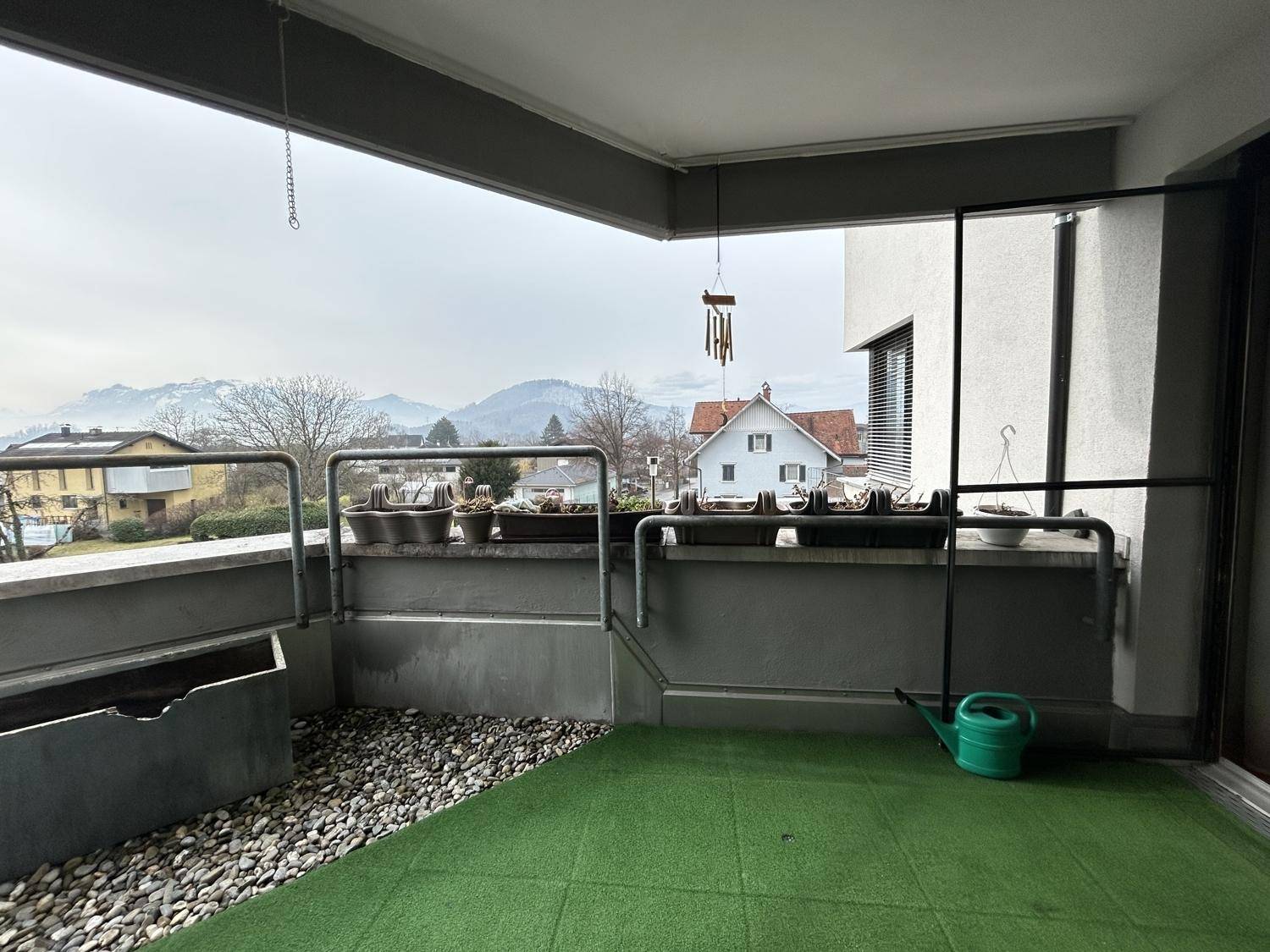 Balkon mit Kunstrasen und Bergblick, ideal für entspannte Stunden im Freien.