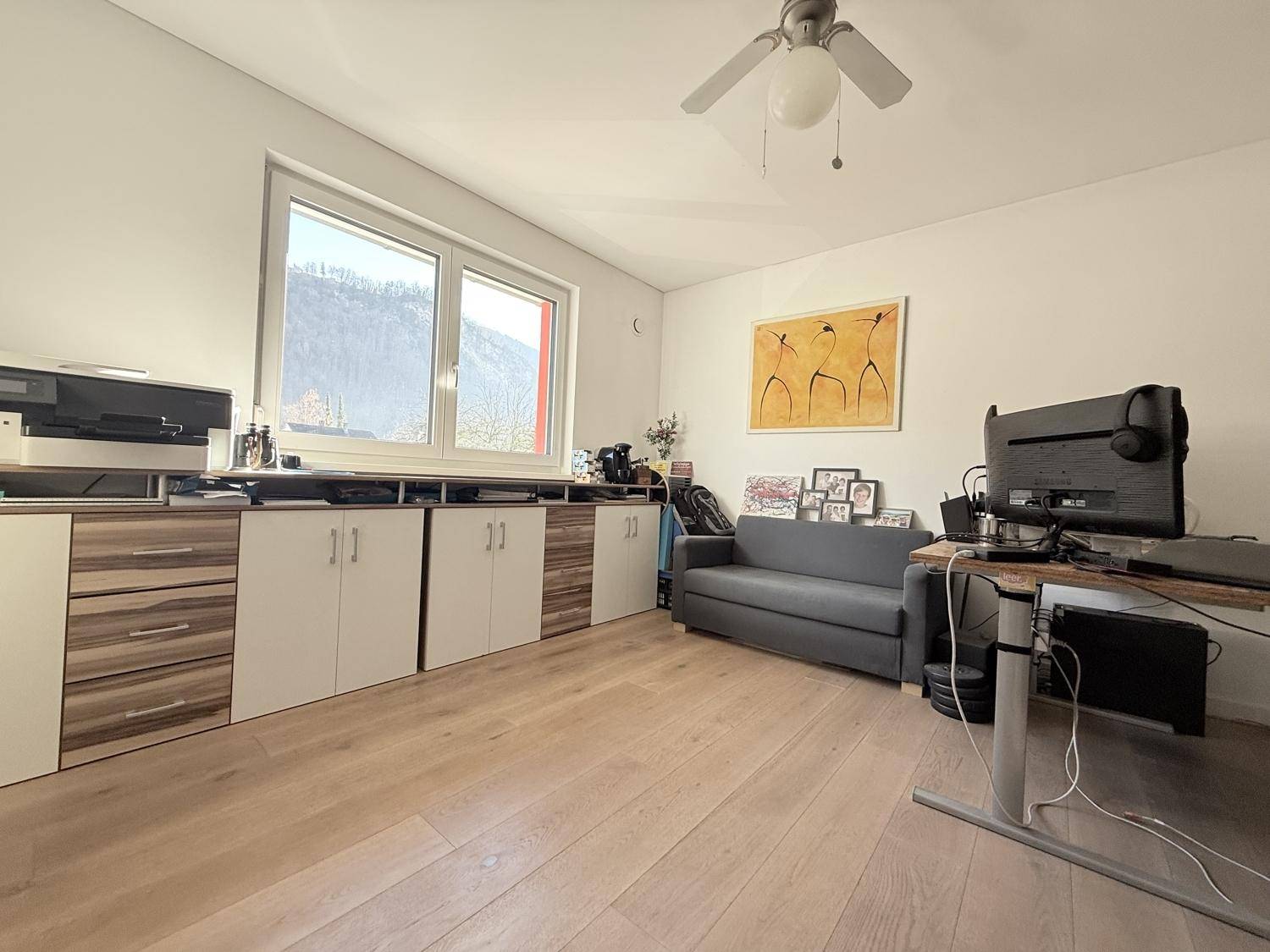 Geräumiges Arbeitszimmer mit viel Stauraum, Schreibtisch und Bergblick.
