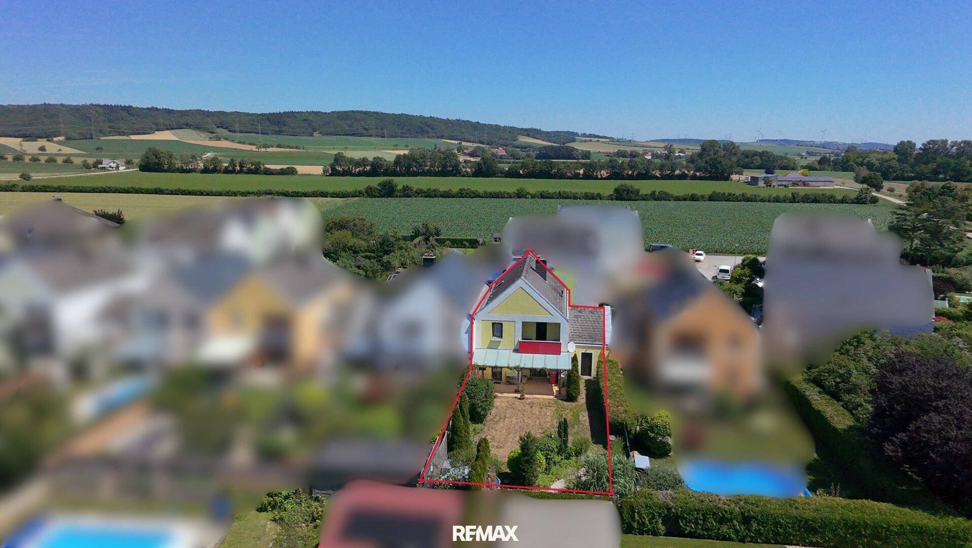 Vogelperspektive des Hauses mit Garten, Terrasse und weitem Blick über die Landschaft.
