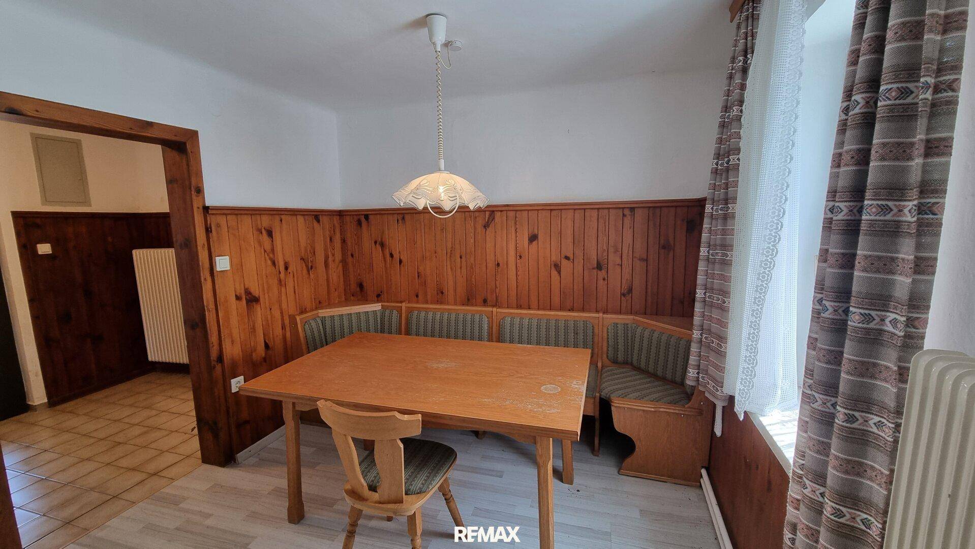 Gemütlicher Essbereich mit Holztäfelung, Eckbank und traditionellem Holztisch.