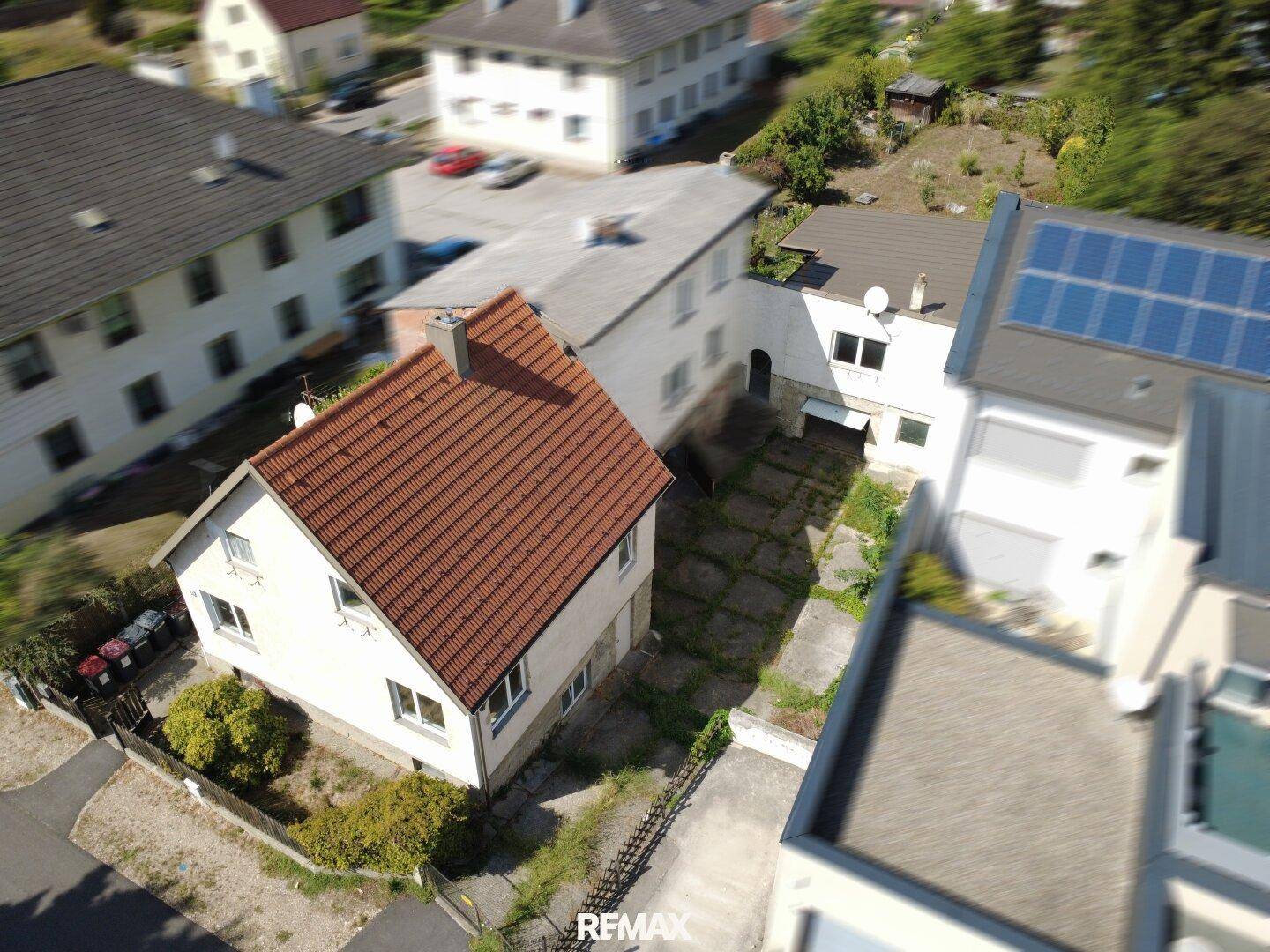 Luftaufnahme des Hauses und der umliegenden Gebäude in einer Wohngegend.