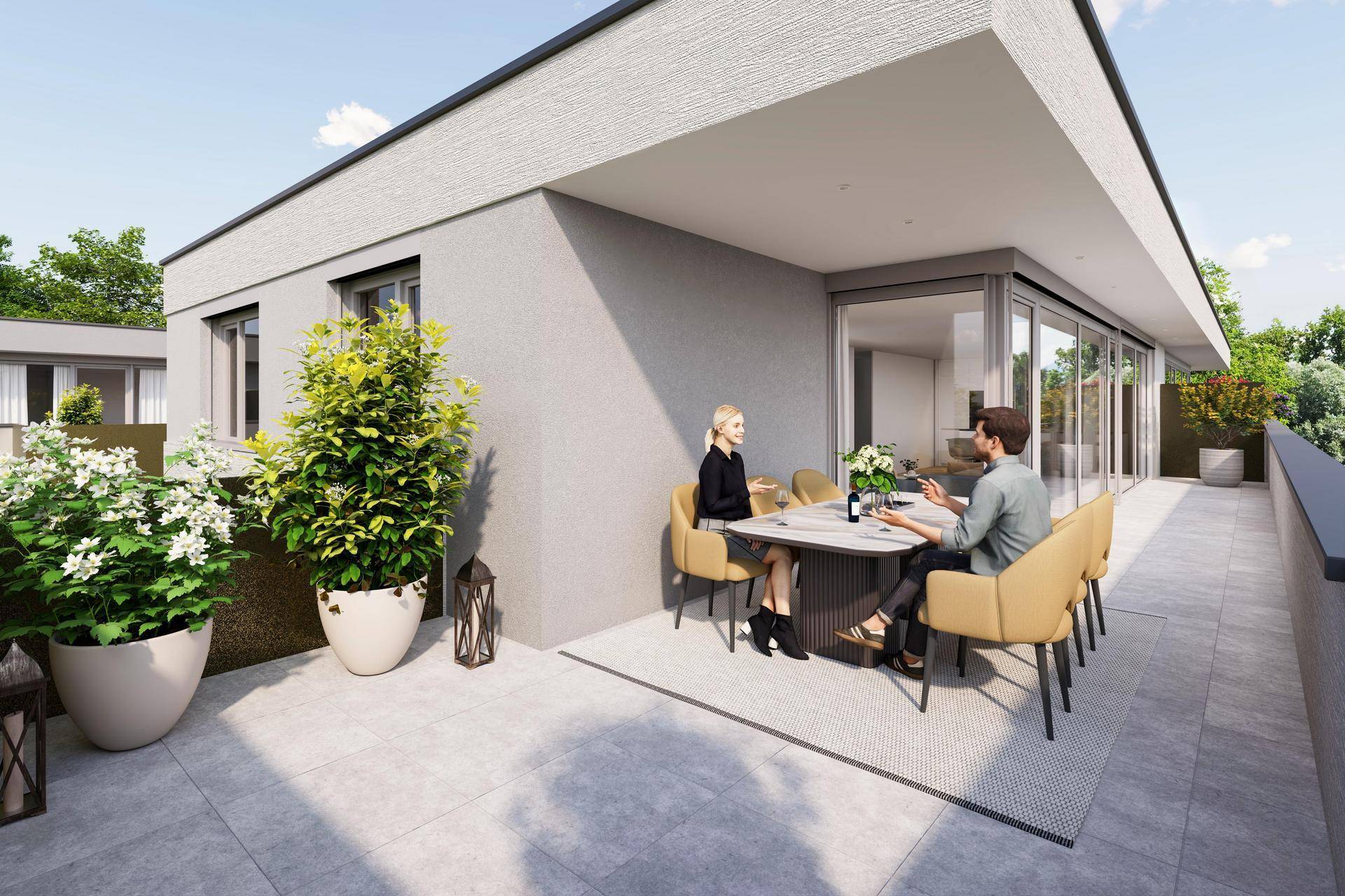 Moderne Terrasse mit Essbereich im Freien, umgeben von Pflanzen und mit Zugang zum Innenbereich.