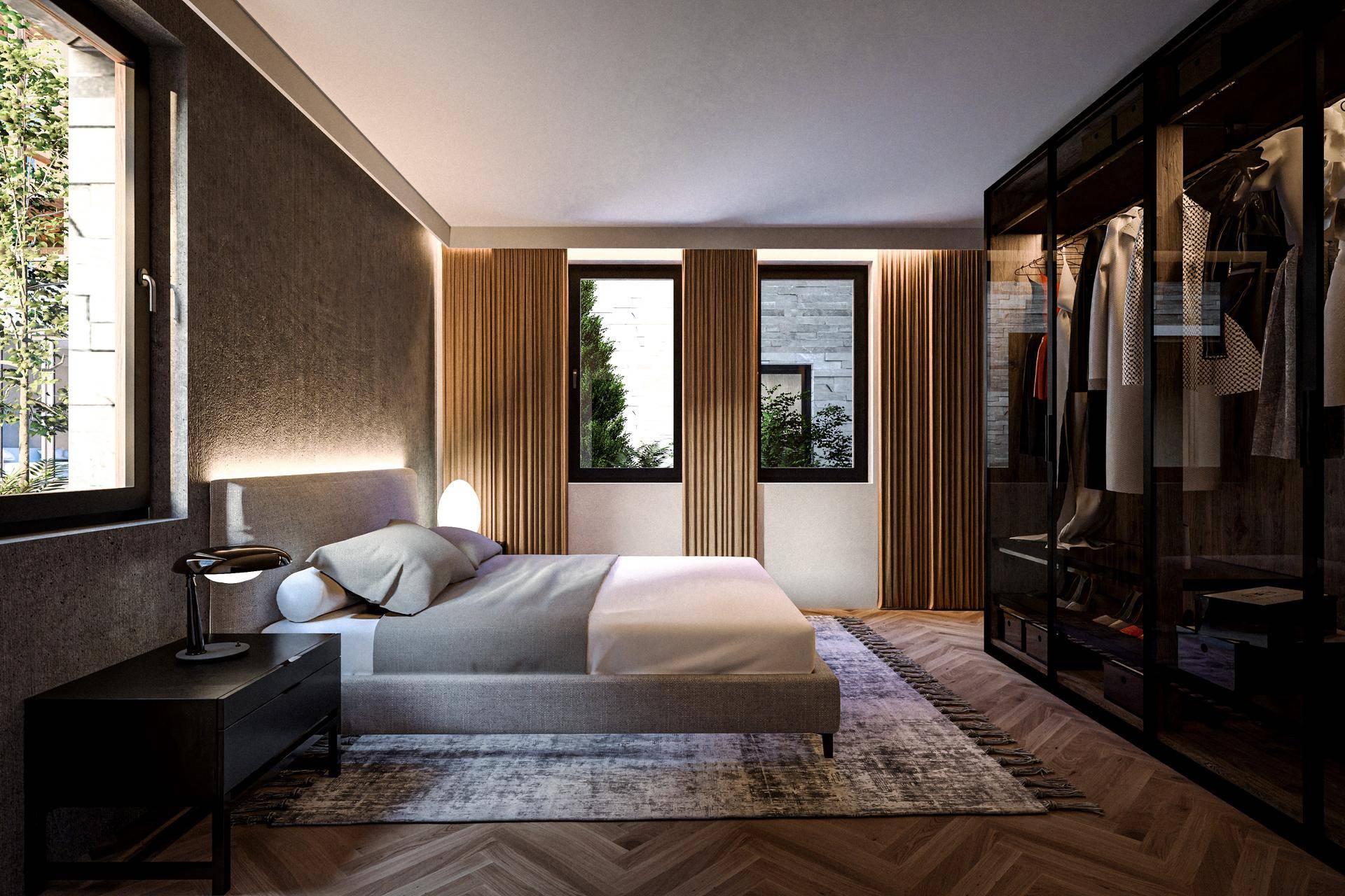 Schlafzimmer mit großem Bett, integriertem begehbarem Kleiderschrank und natürlichem Lichteinfall.