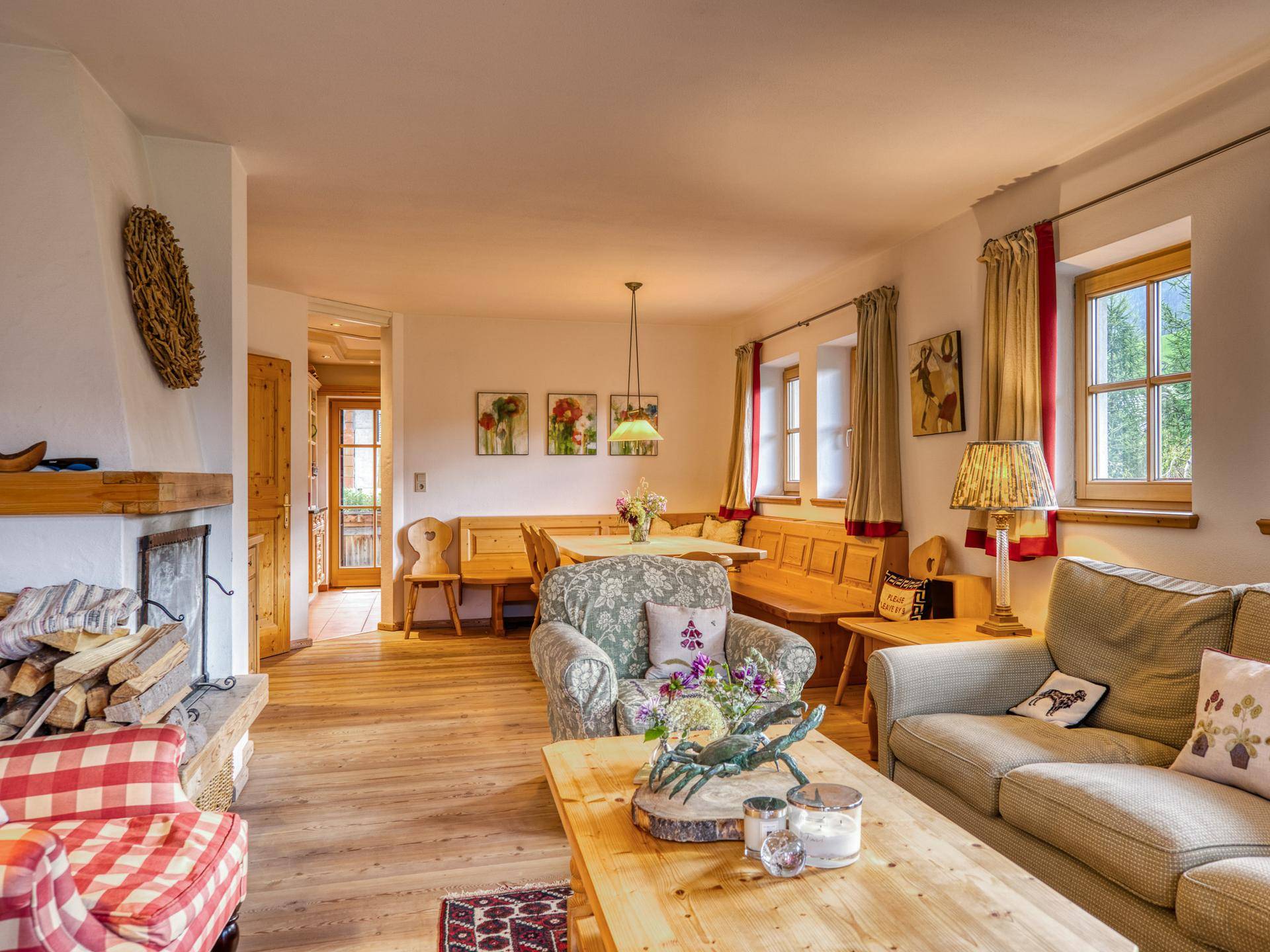 Heller Wohn- und Essbereich im alpinen Stil mit Holzboden, Kamin und traditionellen Möbeln.