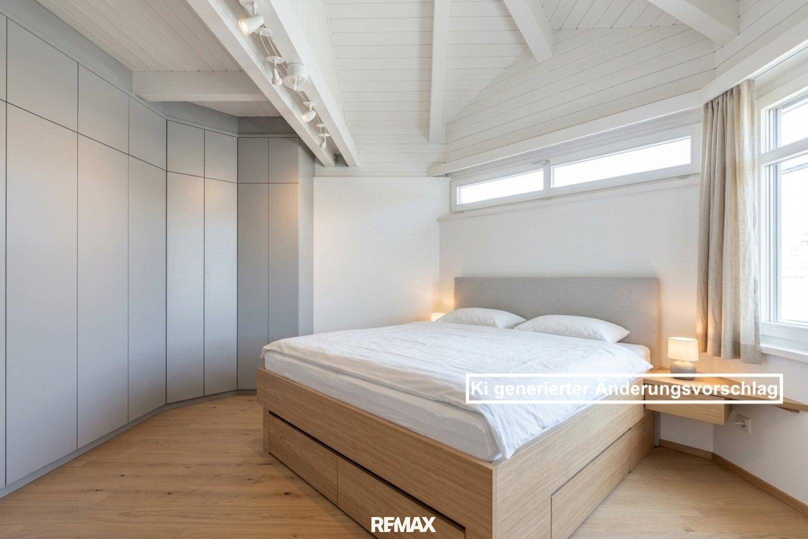 Schlafzimmer mit Einbauschränken, Holzbalkendecke und hellem Holzboden.