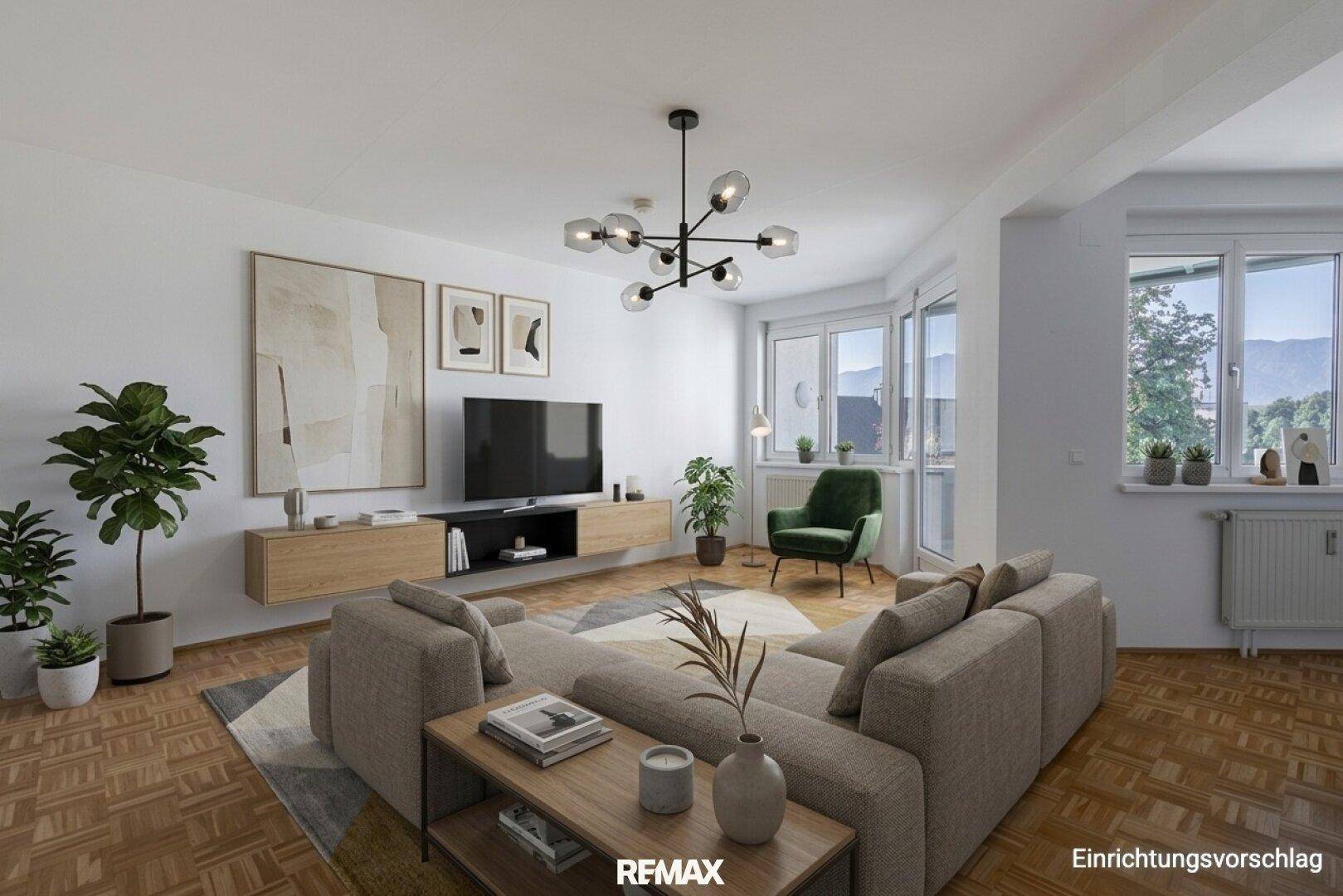 Virtuell möbliertes Wohnzimmer mit modernem Sofa, Fernseher und Blick auf die umliegende Landschaft.