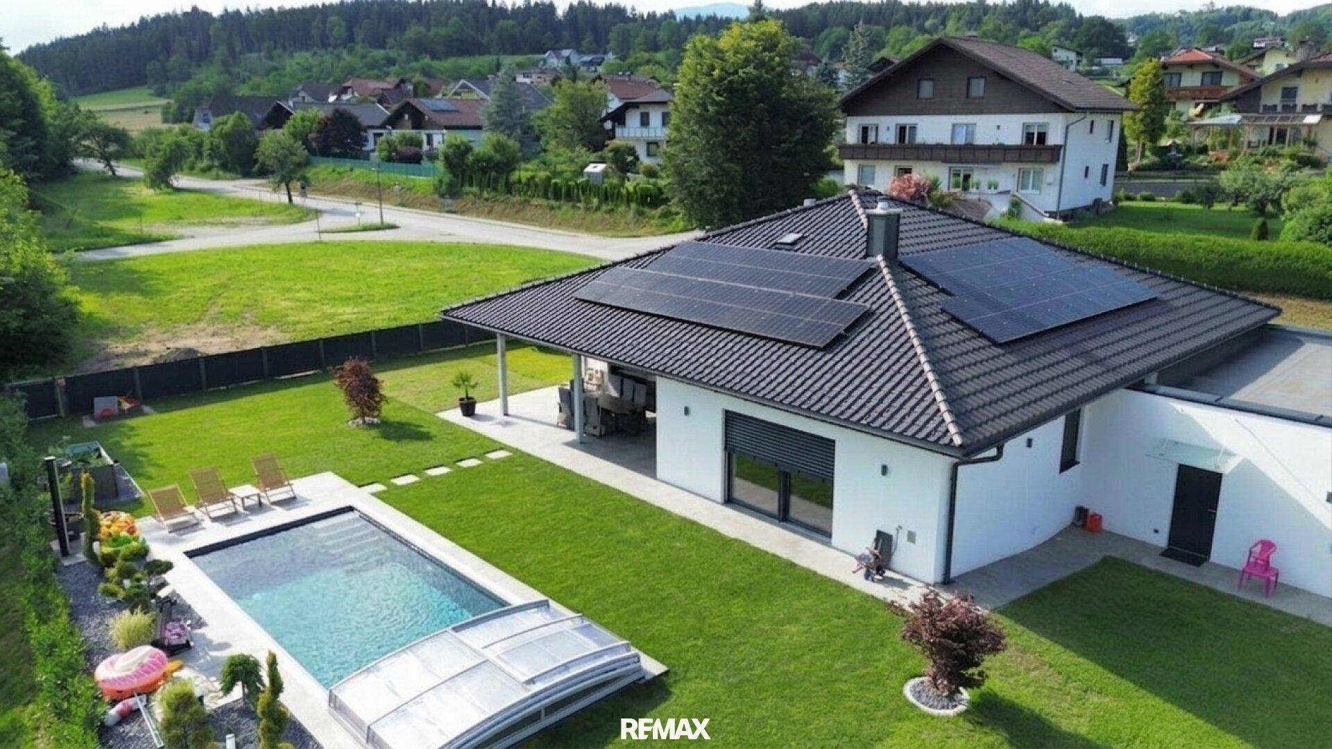 Luftaufnahme des Anwesens mit modernem Haus, Swimmingpool, großem Garten und ländlicher Umgebung.