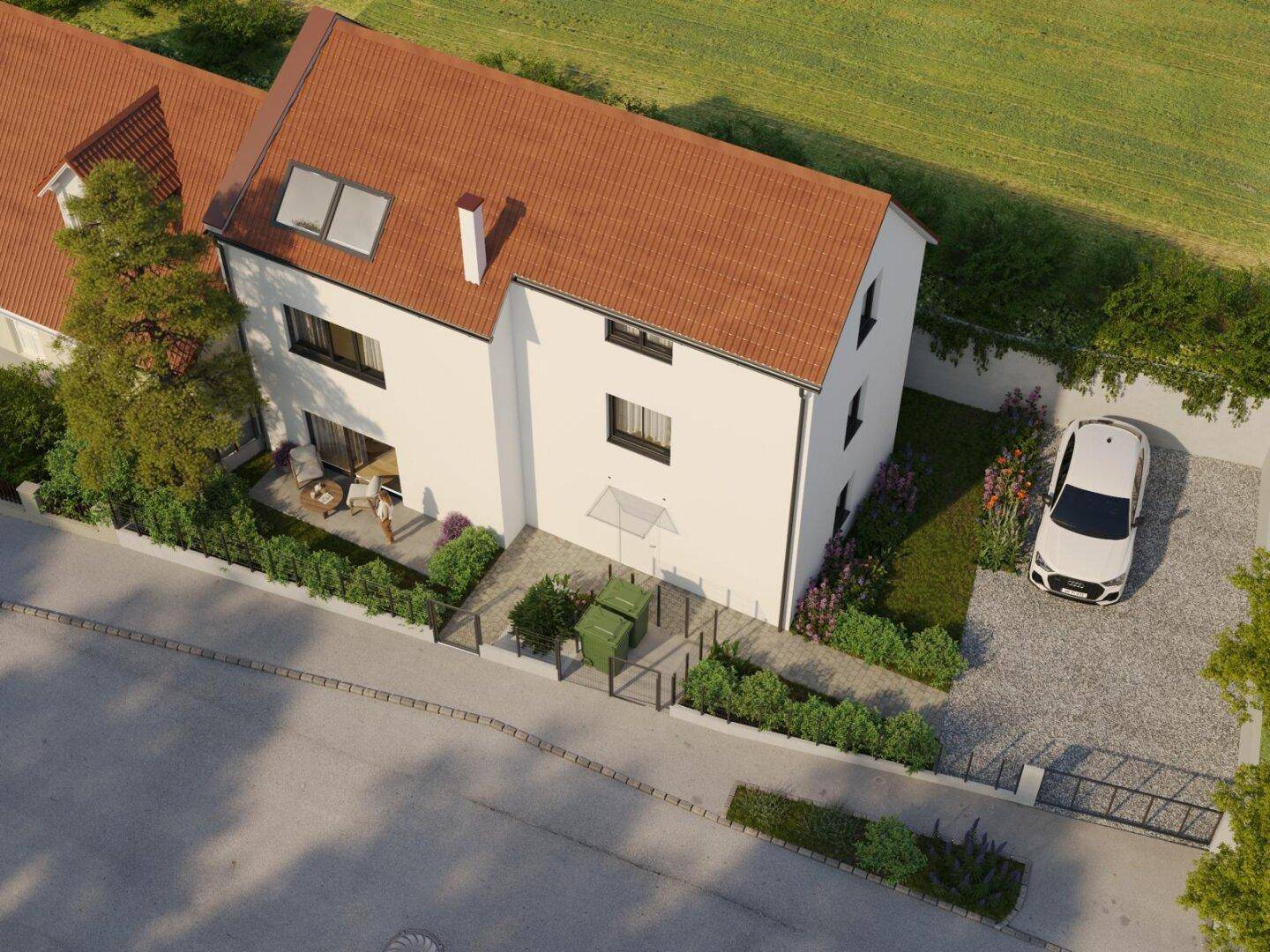 Luftaufnahme des Neubaus mit Gartenbereich, Terrasse und Stellplatz.