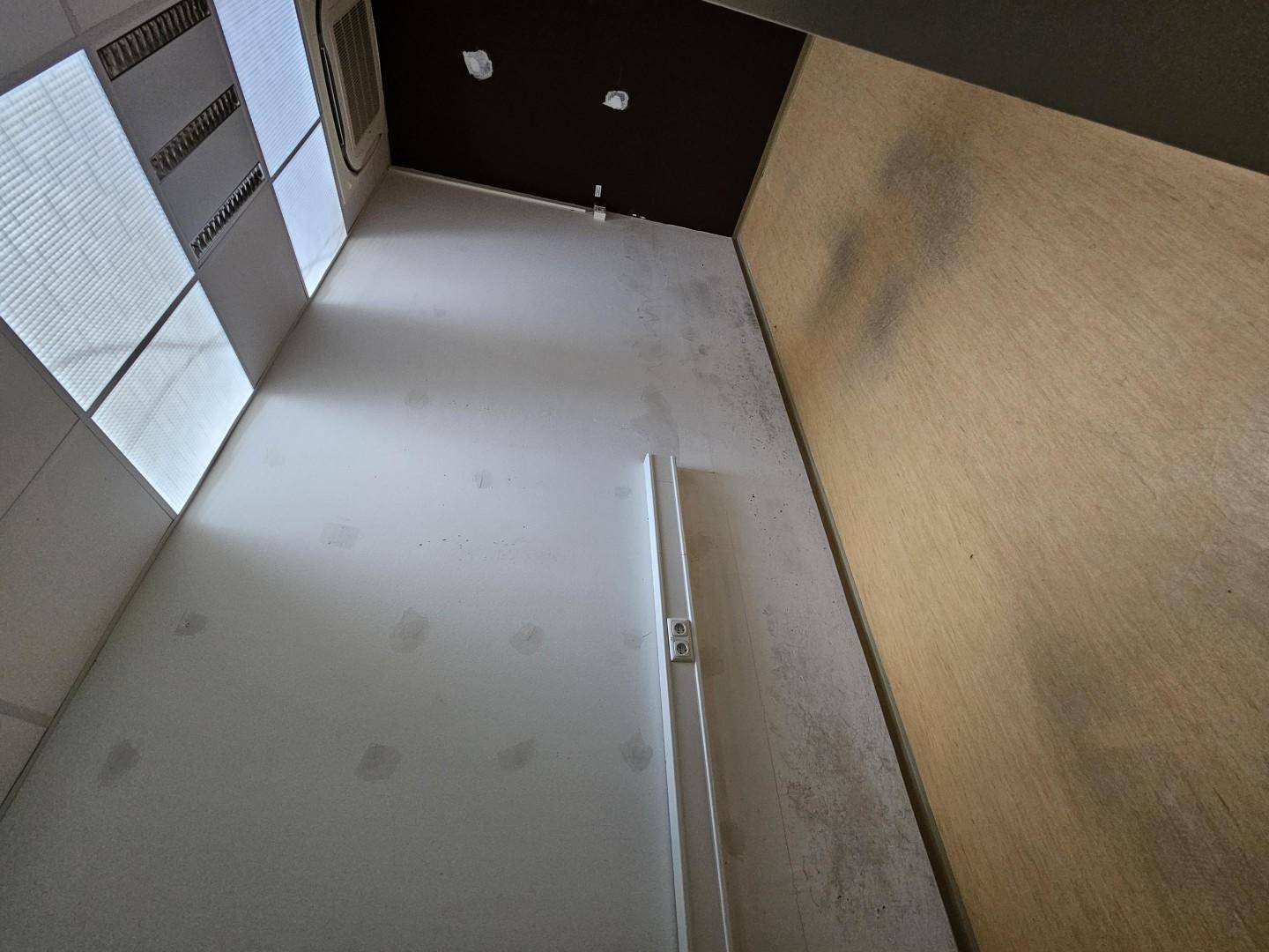 Innenraum mit schrägen Wänden, einem Fenster und sichtbaren Deckenstrukturen, möglicherweise ein Abstellraum.