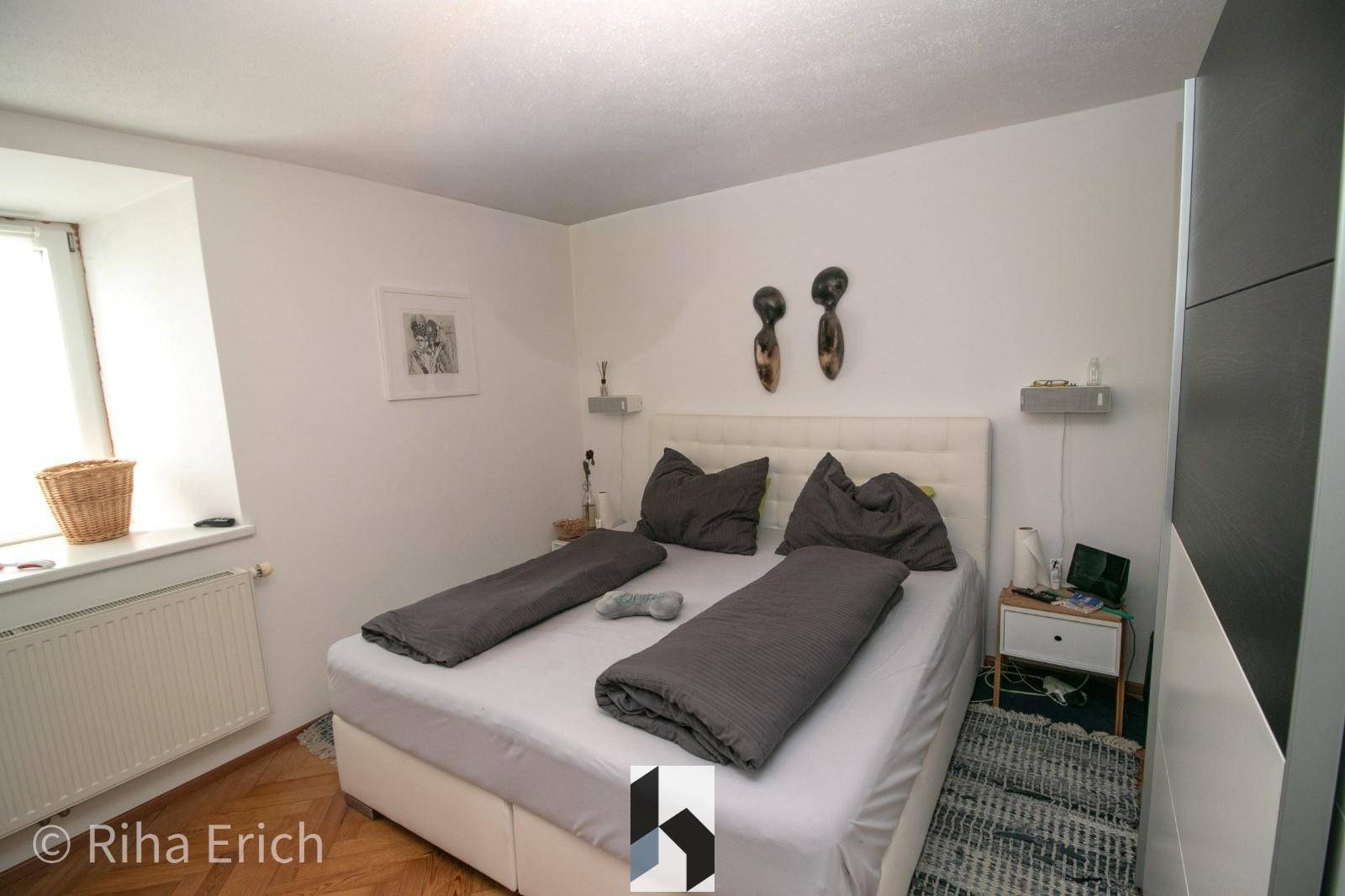Gemütliches Schlafzimmer mit Doppelbett, Nachttischen und einem Fenster für natürliches Licht und Komfort.