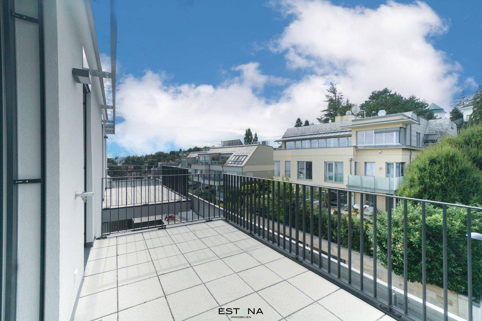 Balkon mit Blick auf benachbarte Gebäude und die grüne Umgebung, ideal zum Entspannen.