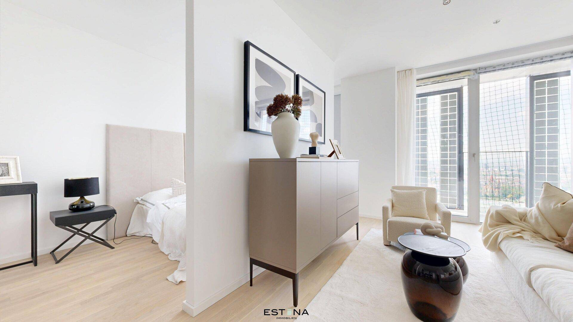 Modern eingerichtetes Wohnzimmer mit hellem Parkettboden und Zugang zu einem Außenbereich.