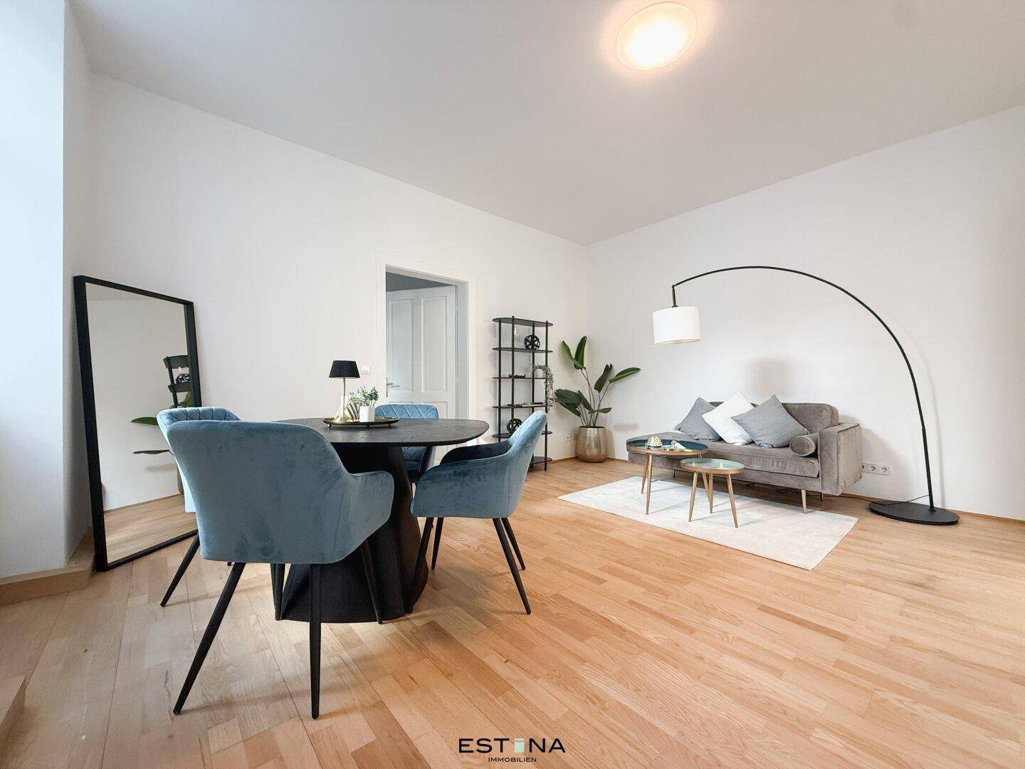 Offener Wohn- und Essbereich mit viel Tageslicht und elegantem Parkettboden, ideal für moderne Wohnkonzepte.