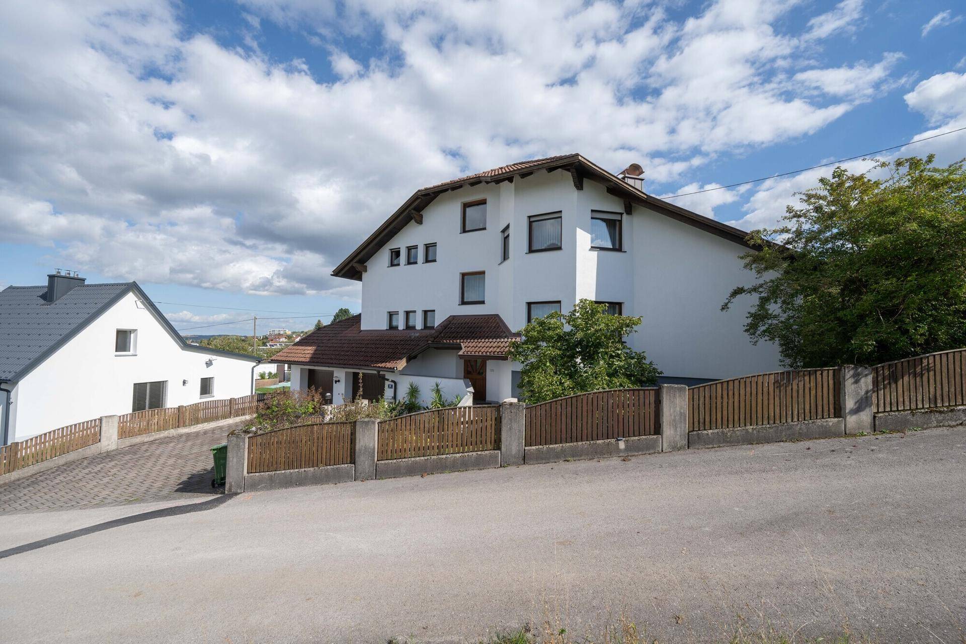 Ansicht des Einfamilienhauses von der Straße mit gepflegter Auffahrt und Doppelgarage.