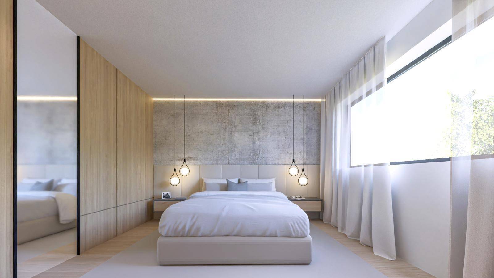 Helles Schlafzimmer mit Holzwand, Doppelbett und integrierten Schränken.