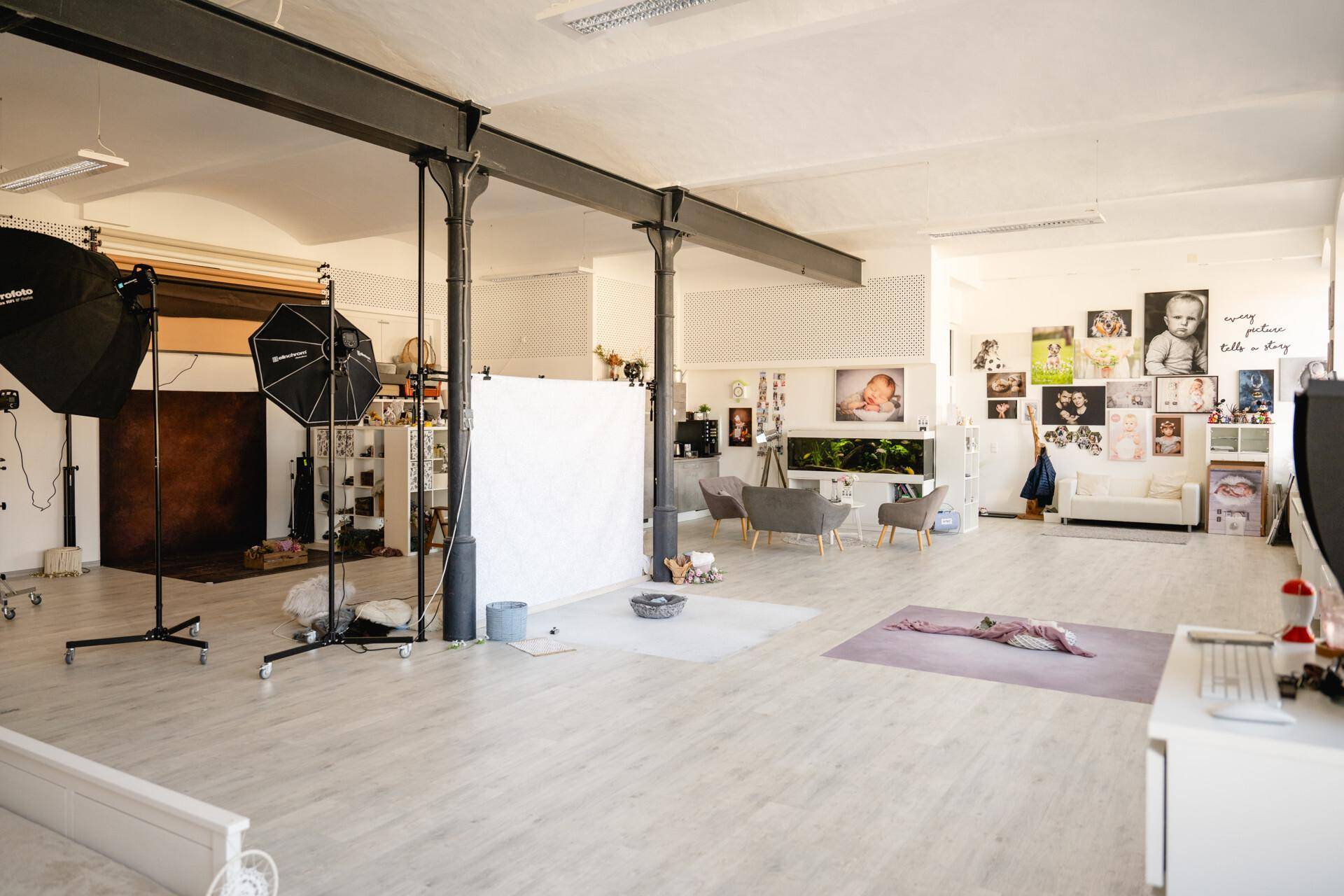 Weitläufiges Fotostudio mit verschiedenen Aufnahmebereichen, Requisiten und professioneller Ausrüstung.