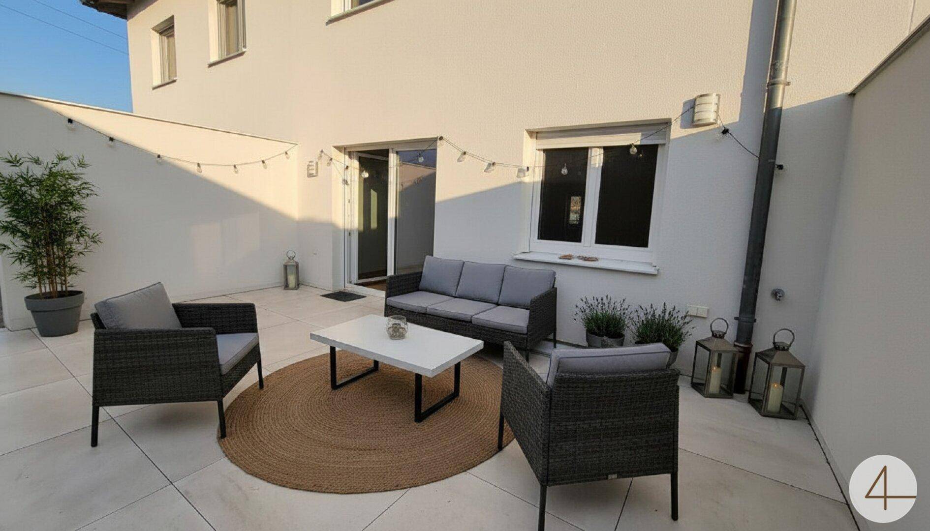 Moderne Terrasse mit bequemen Lounge-Möbeln und dekorativer Beleuchtung für entspannte Abende.