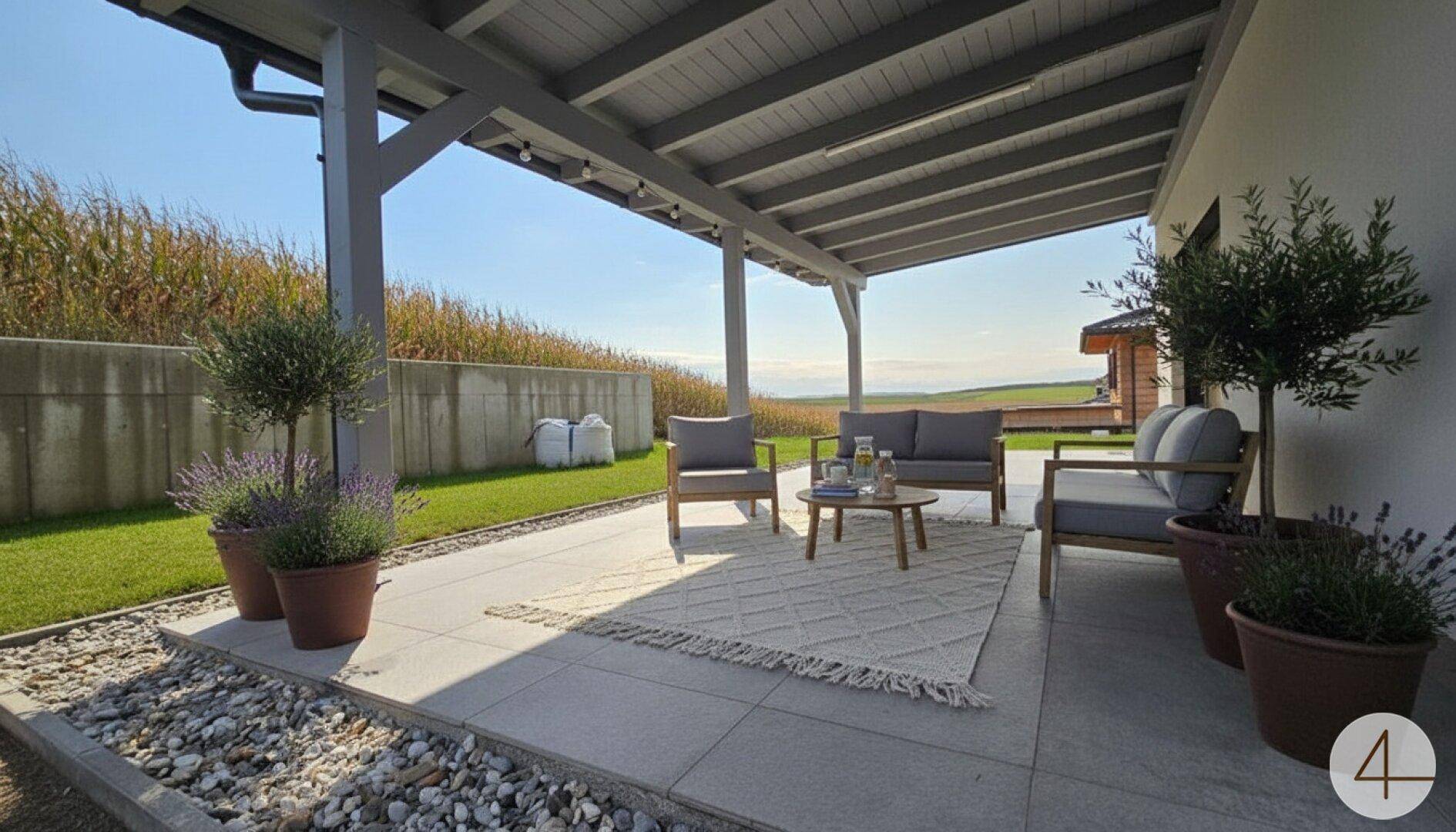 Große überdachte Terrasse mit bequemen Gartenmöbeln und weitem Blick ins Grüne.