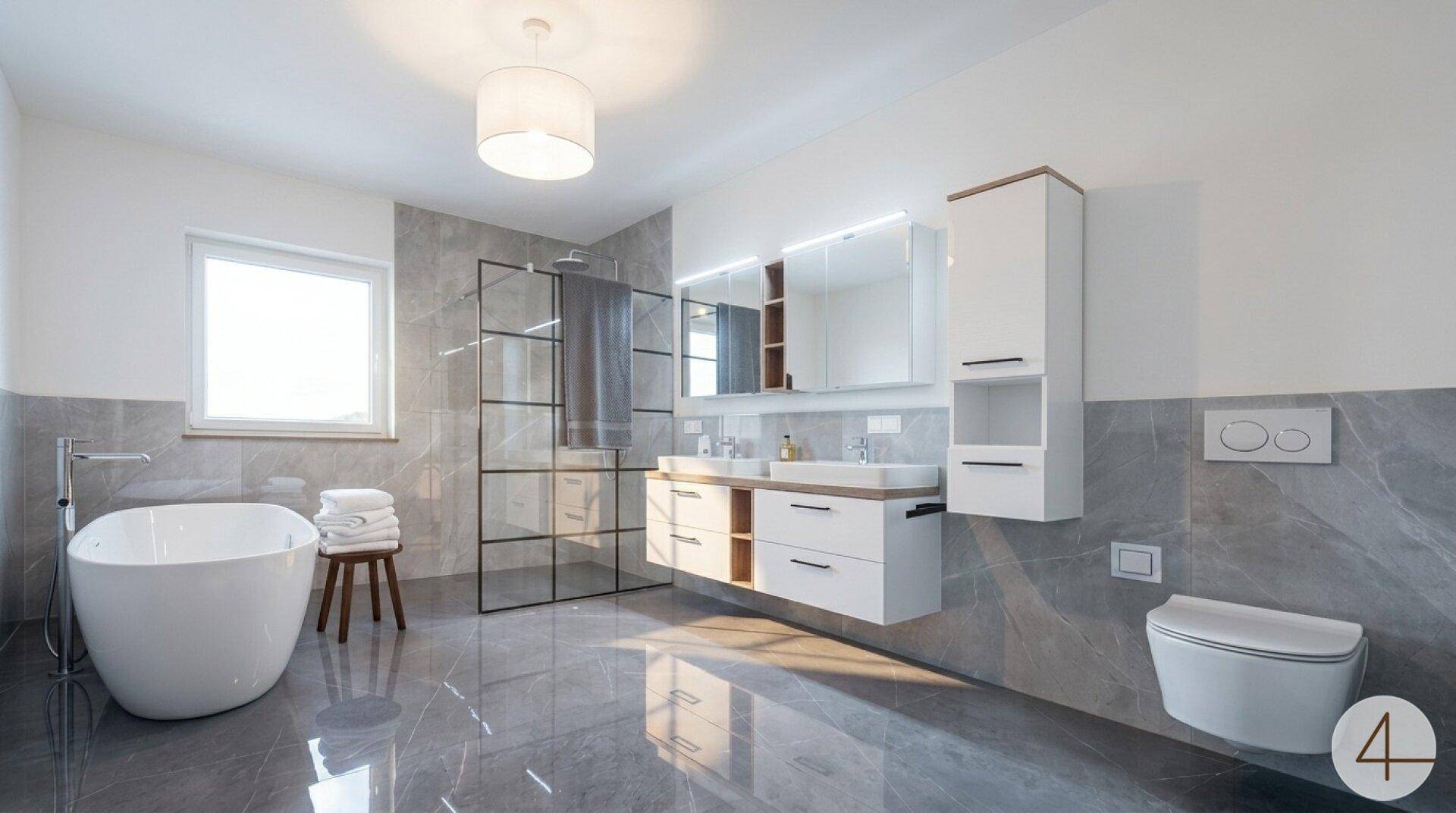 Luxuriöses Badezimmer mit freistehender Badewanne, Doppelwaschbecken und großer Dusche.