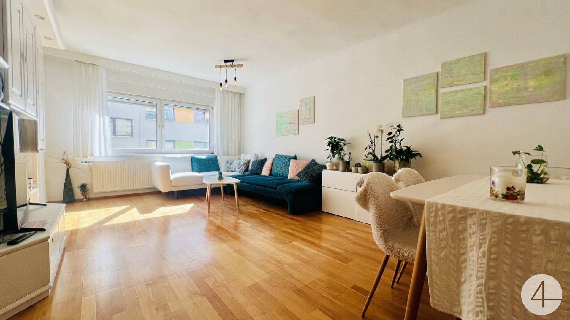 Geräumiger Wohn-Essbereich mit viel Tageslicht, Holzboden und moderner Einrichtung.