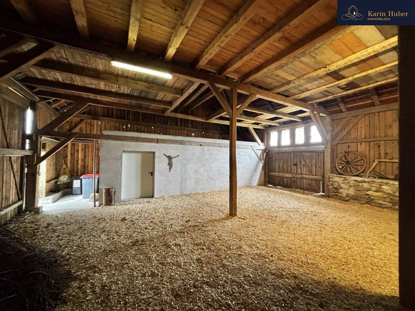 Große Scheune mit Holzbalkenkonstruktion und Holzboden, bereit zur Nutzung.