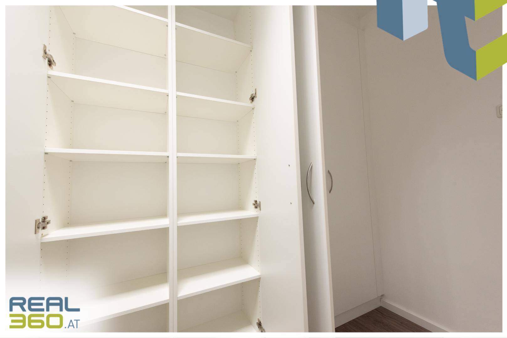 Offener Einbauschrank mit mehreren Regalböden, ideal für Lagerung oder Akten.