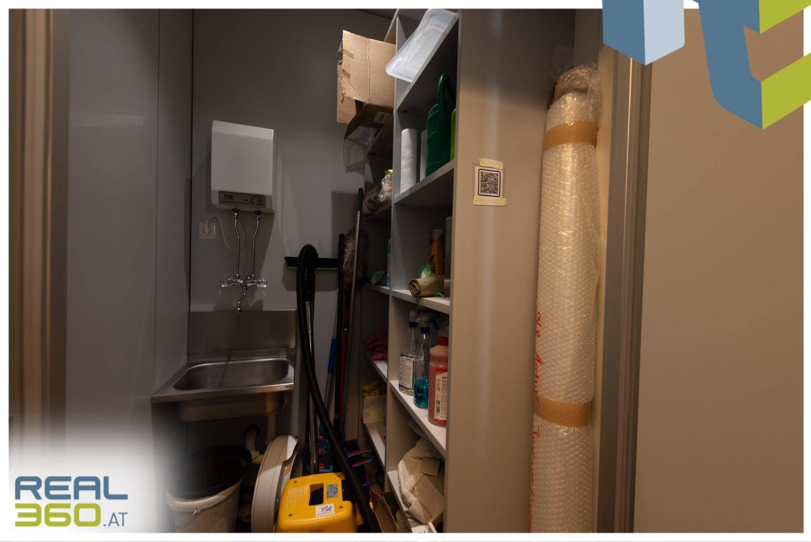 Praktischer Hauswirtschaftsraum mit kleinem Waschbecken, Regalen und Reinigungsutensilien, gut ausgestattet.