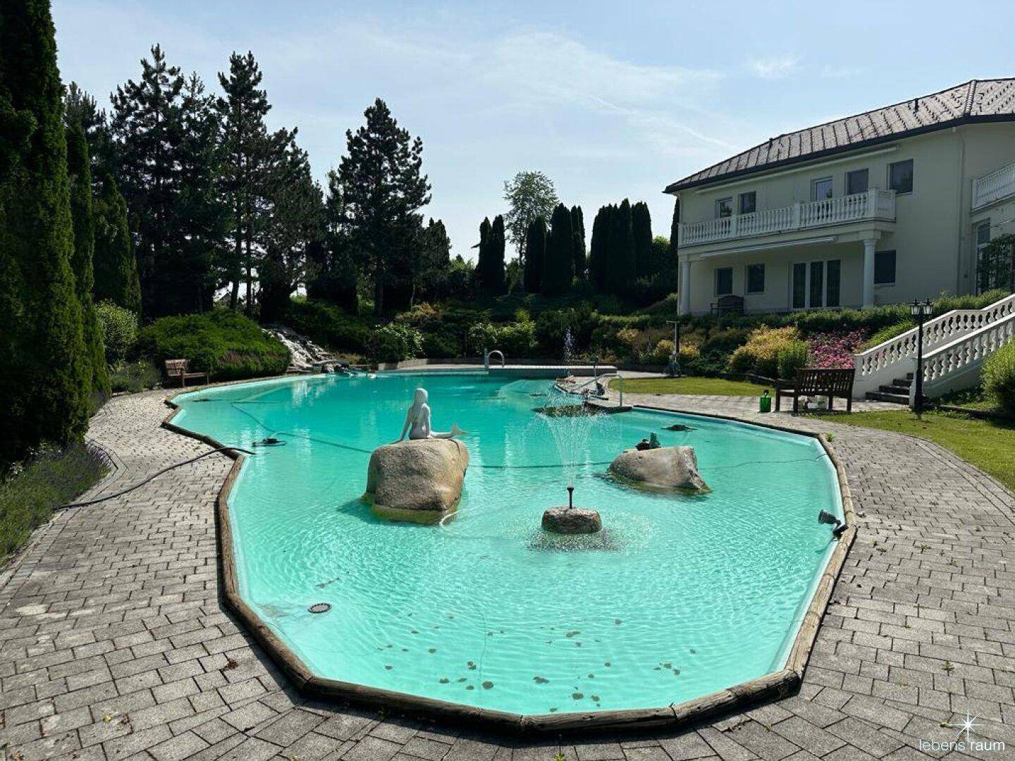 Pool mit Springbrunnen und Wasserfall.