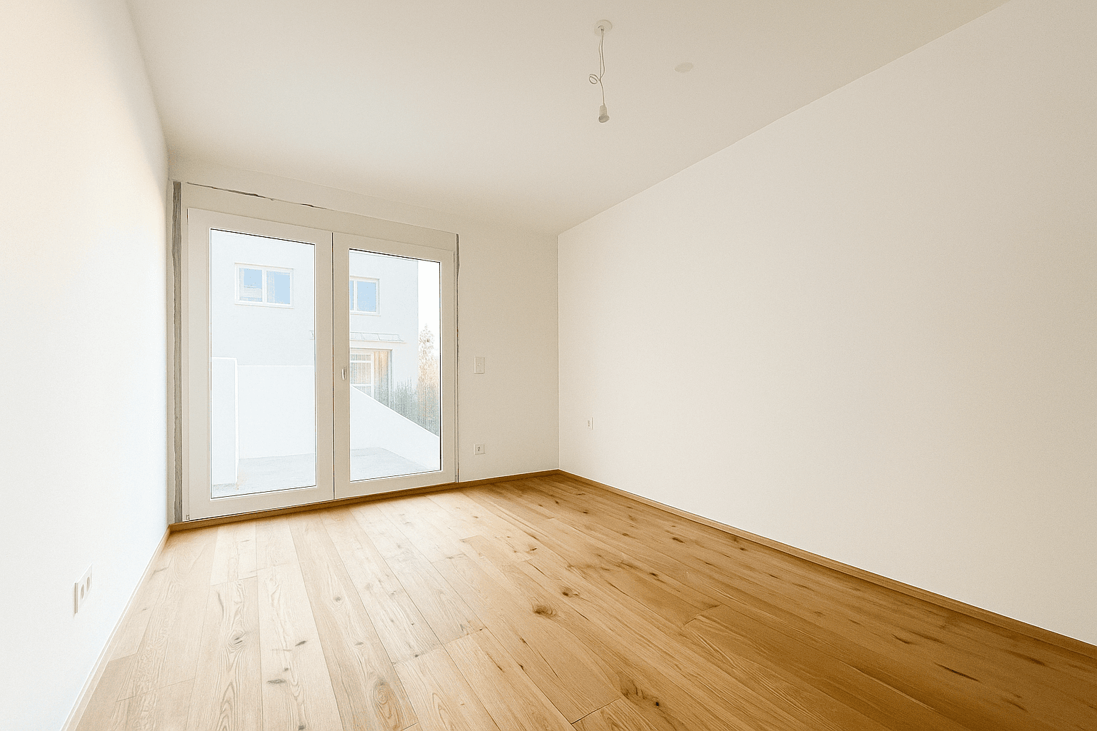 Geräumiges Schlafzimmer mit Holzboden und großen Fenstern, die den Raum hell und freundlich machen.