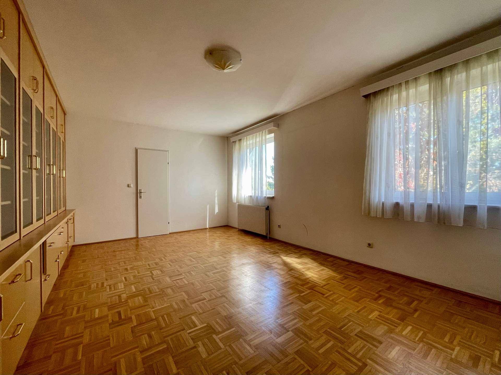 Helles Schlafzimmer mit Parkettboden und Einbauschränken, ideal für individuelle Einrichtung.