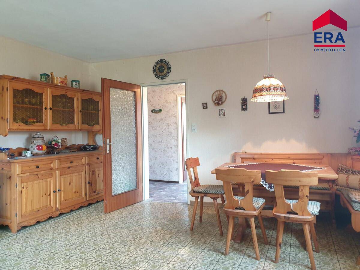 Gemütlicher Essbereich im Landhausstil mit Eckbank, Holztisch und traditionellen Holzmöbeln.