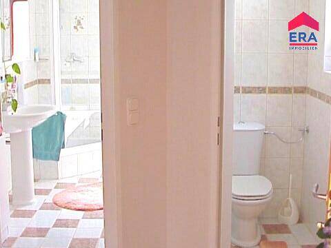 Separates WC mit Toilette und Fliesenboden, funktional und sauber.