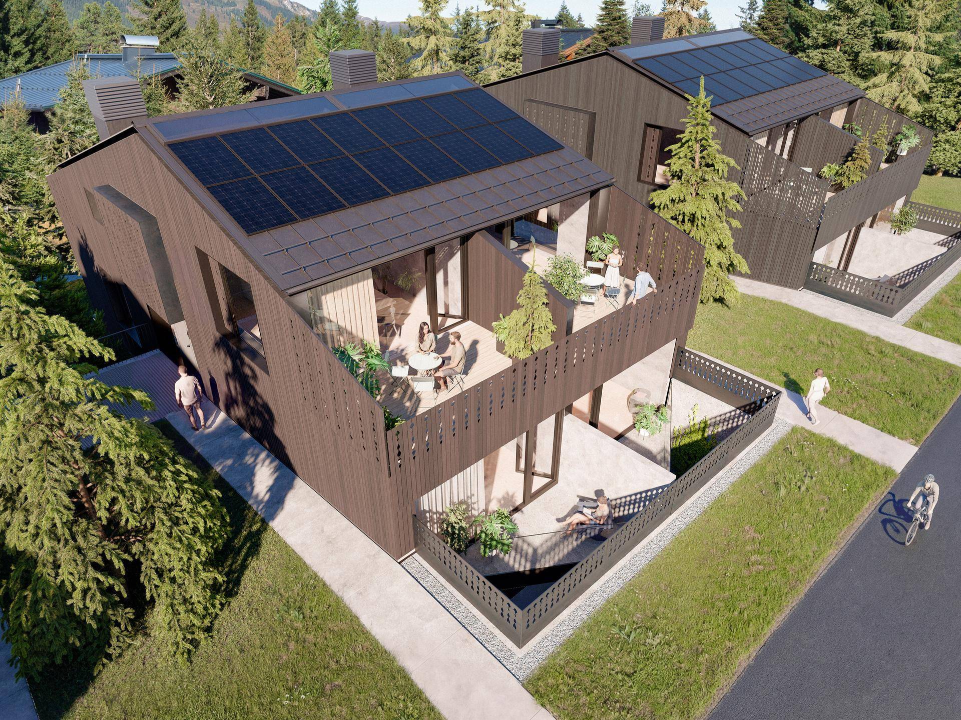 Moderne Häuser mit Solaranlagen auf den Dächern und Terrassen in grüner Umgebung.