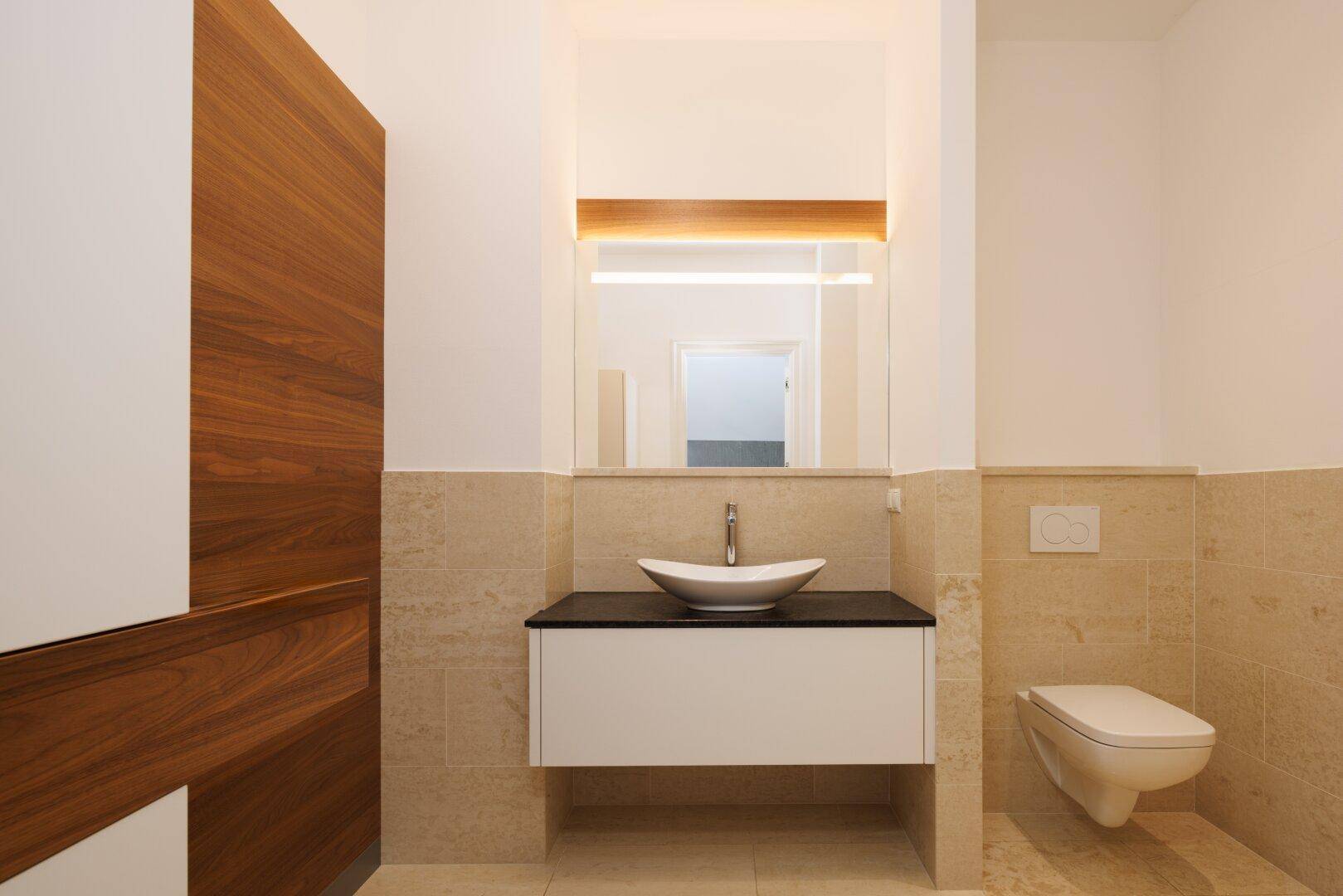 Modernes Gäste-WC mit wandhängendem WC und elegantem Waschbecken, funktional und stilvoll.