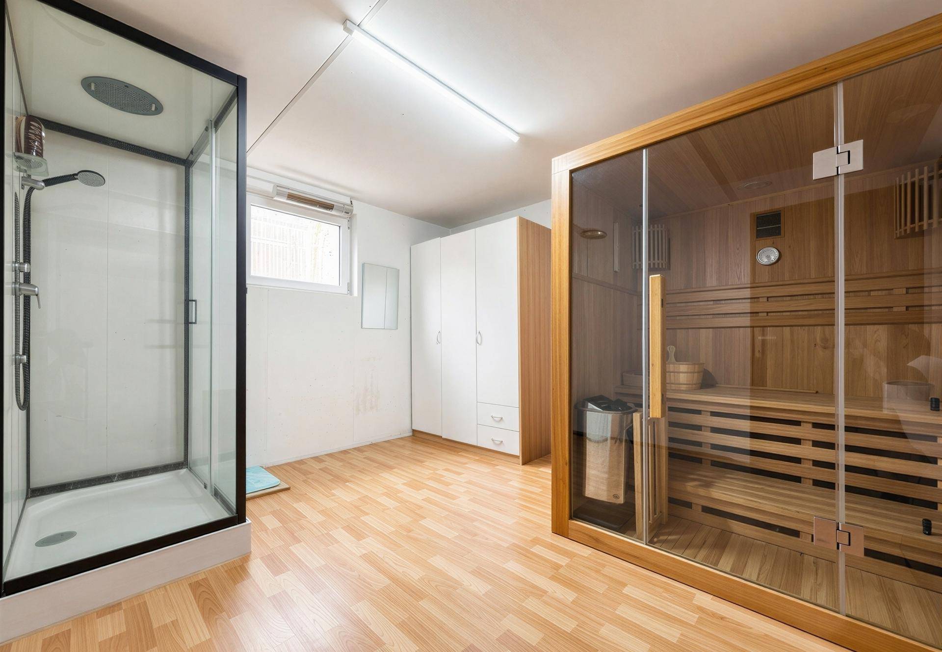 Wellnessbereich im Untergeschoss mit Sauna, Dusche und viel Stauraum.