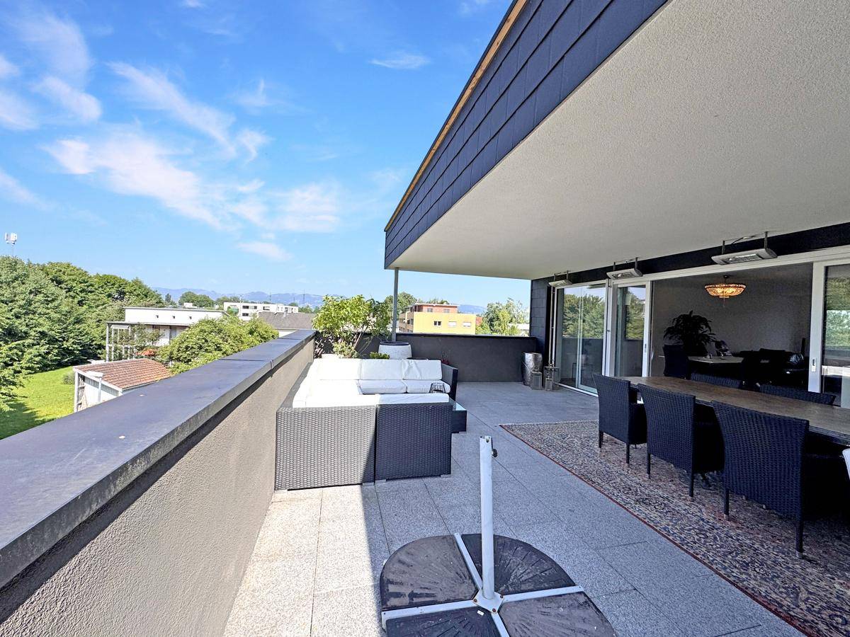 Große Terrasse mit Essbereich und Lounge-Möbeln, ideal für entspannte Stunden im Freien.