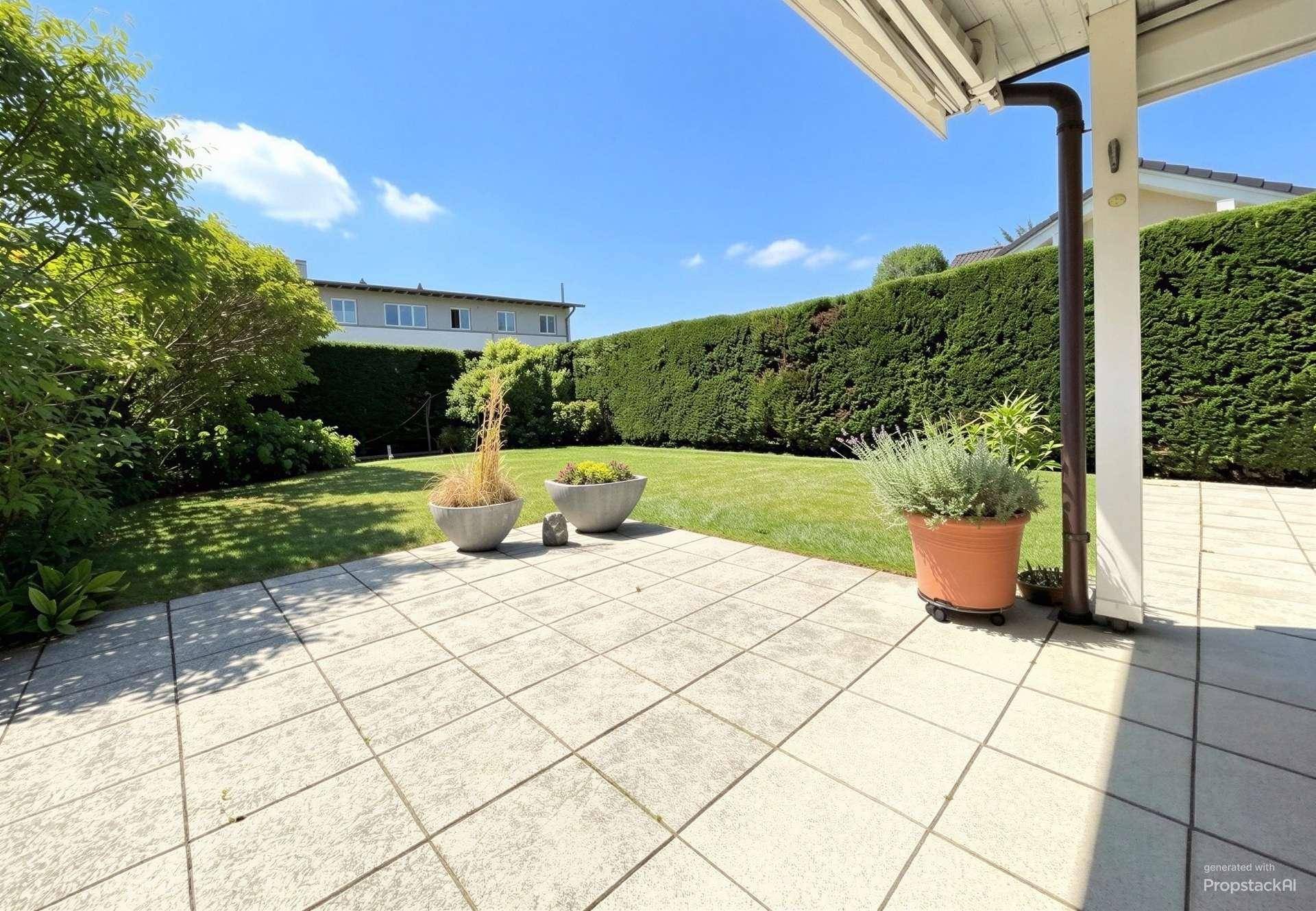 Sonnige Terrasse mit Blick auf den grünen Garten und hohe Hecken.