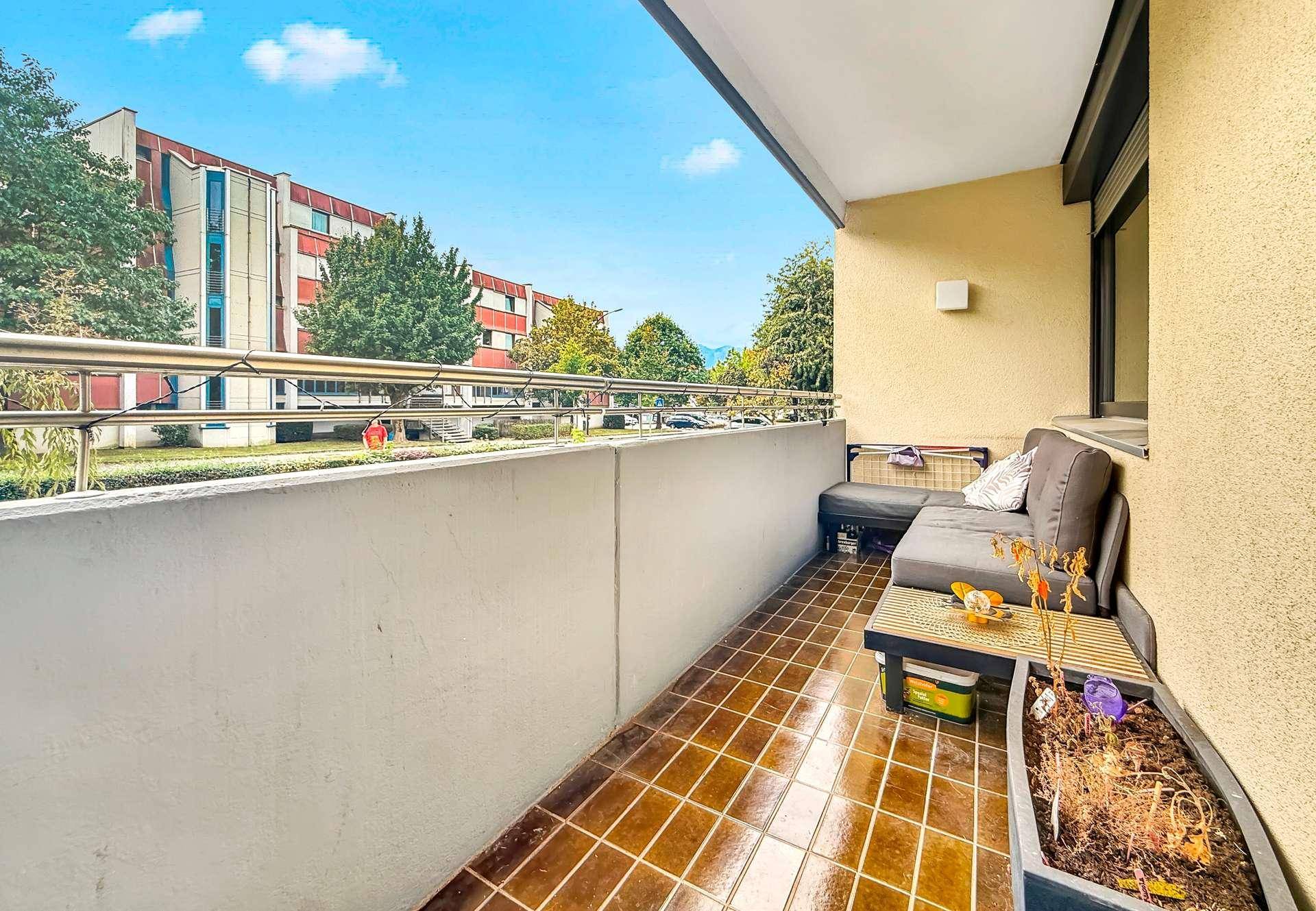 Geräumiger Balkon mit Sitzgelegenheiten und Blick auf die Umgebung und Berge.