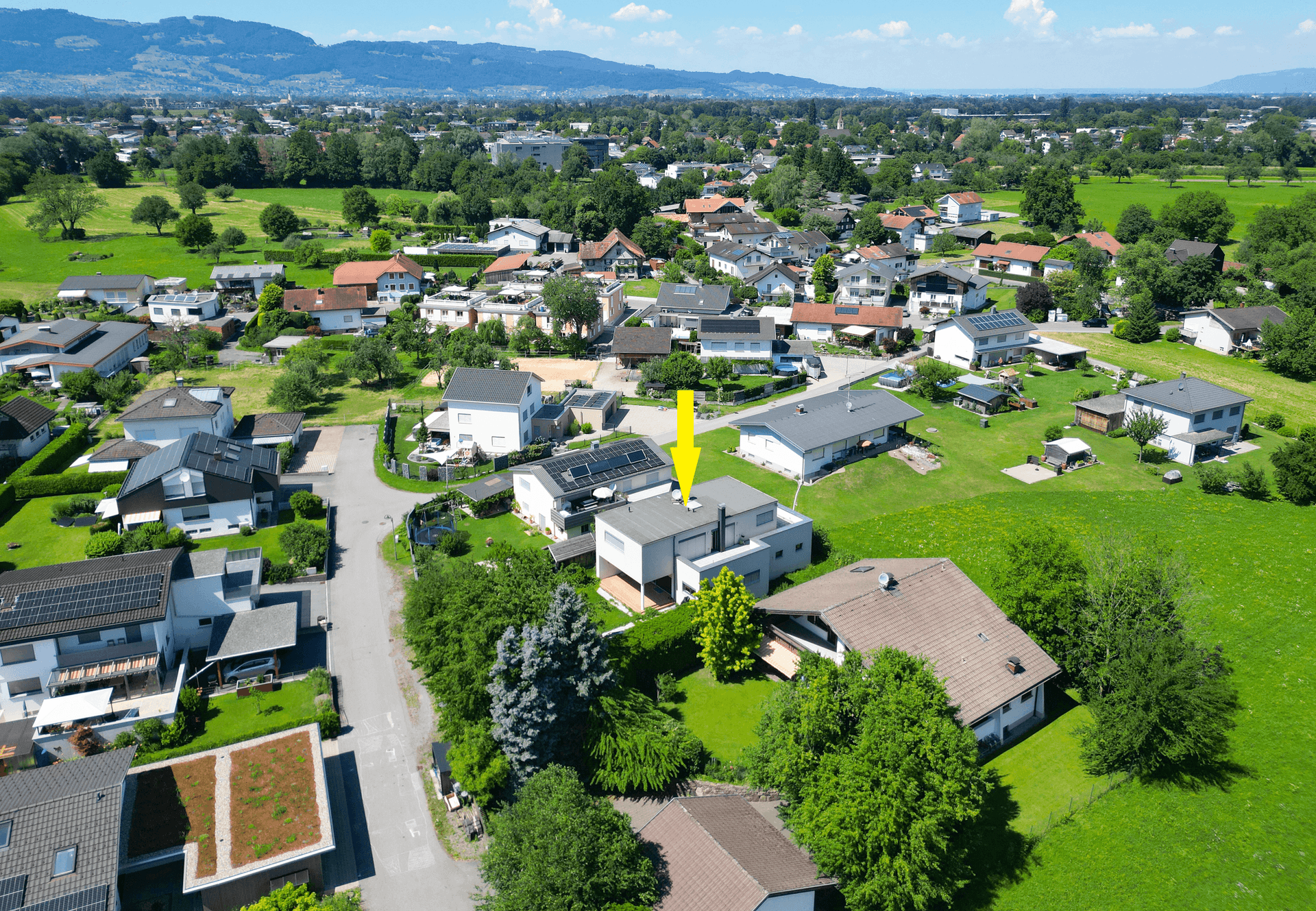 Luftaufnahme des Hauses in einer grünen Wohngegend mit umliegenden Feldern.