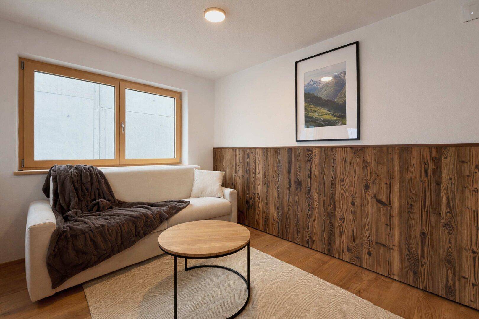 Gemütliches Wohnzimmer mit Sofa, Couchtisch und Holzboden in modernem Design.