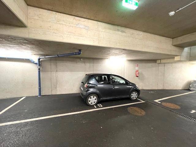 Tiefgaragenstellplatz mit Betonwänden und -decken, bietet sicheren Parkraum für Fahrzeuge.