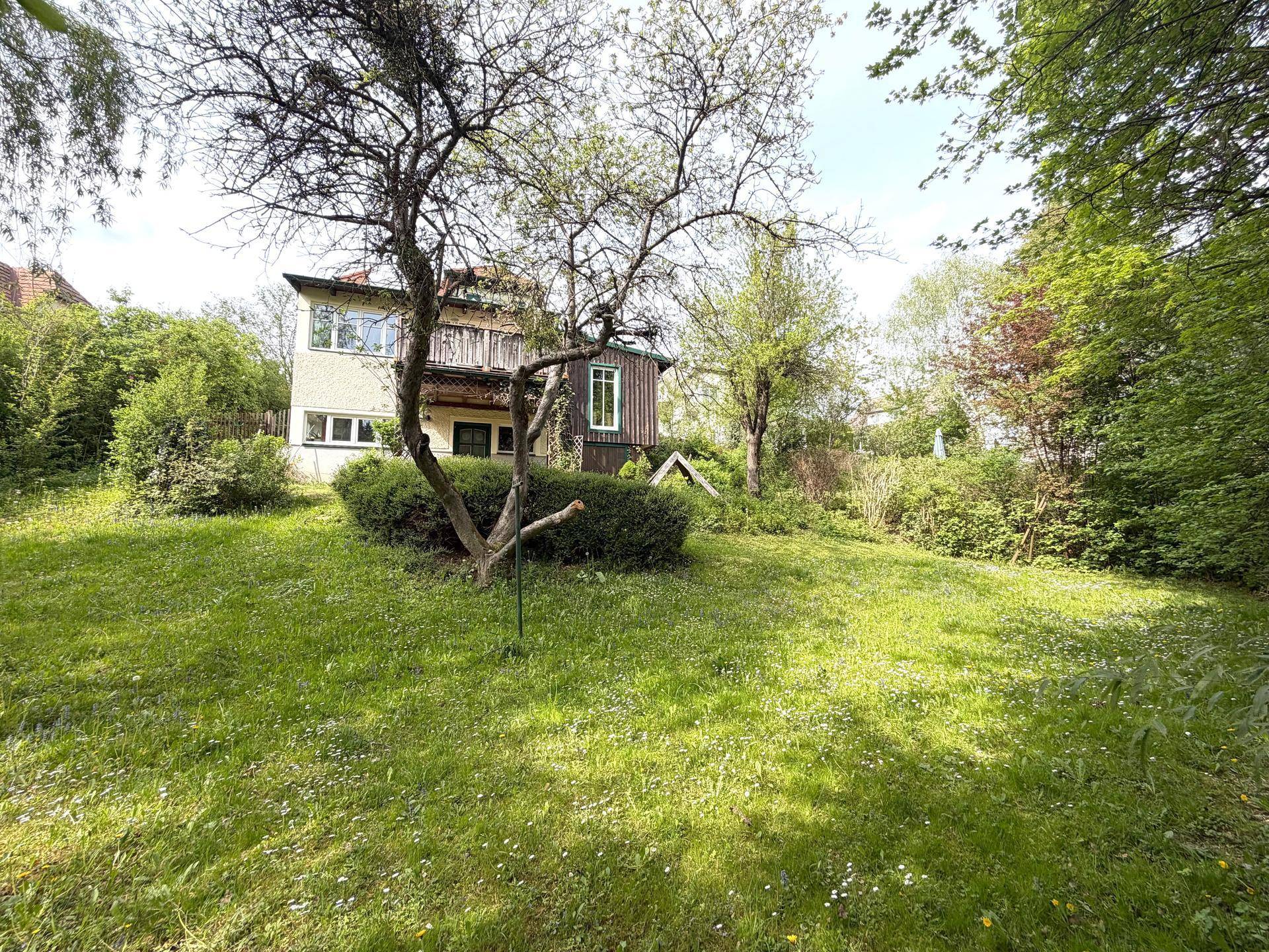 Charmantes Landhaus mit großem Garten und altem Baumbestand in ländlicher Umgebung.