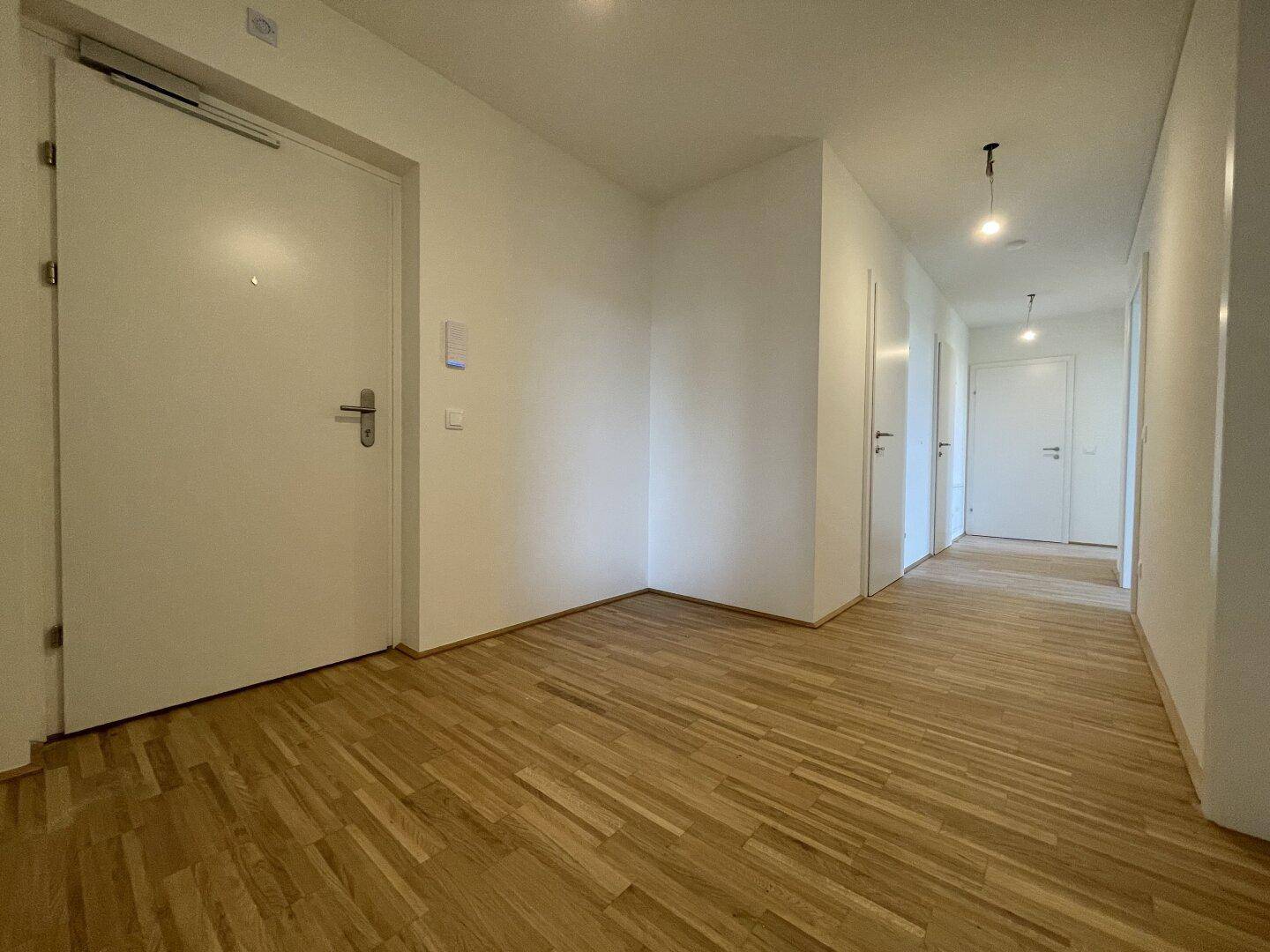 Geräumiger Flur mit Parkettboden und mehreren Türen zu den angrenzenden Räumen.