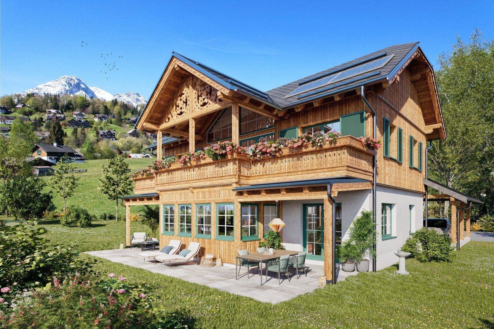 Attraktives Holzchalet mit sonniger Terrasse und Balkonen in einer weitläufigen, grünen Bergumgebung.