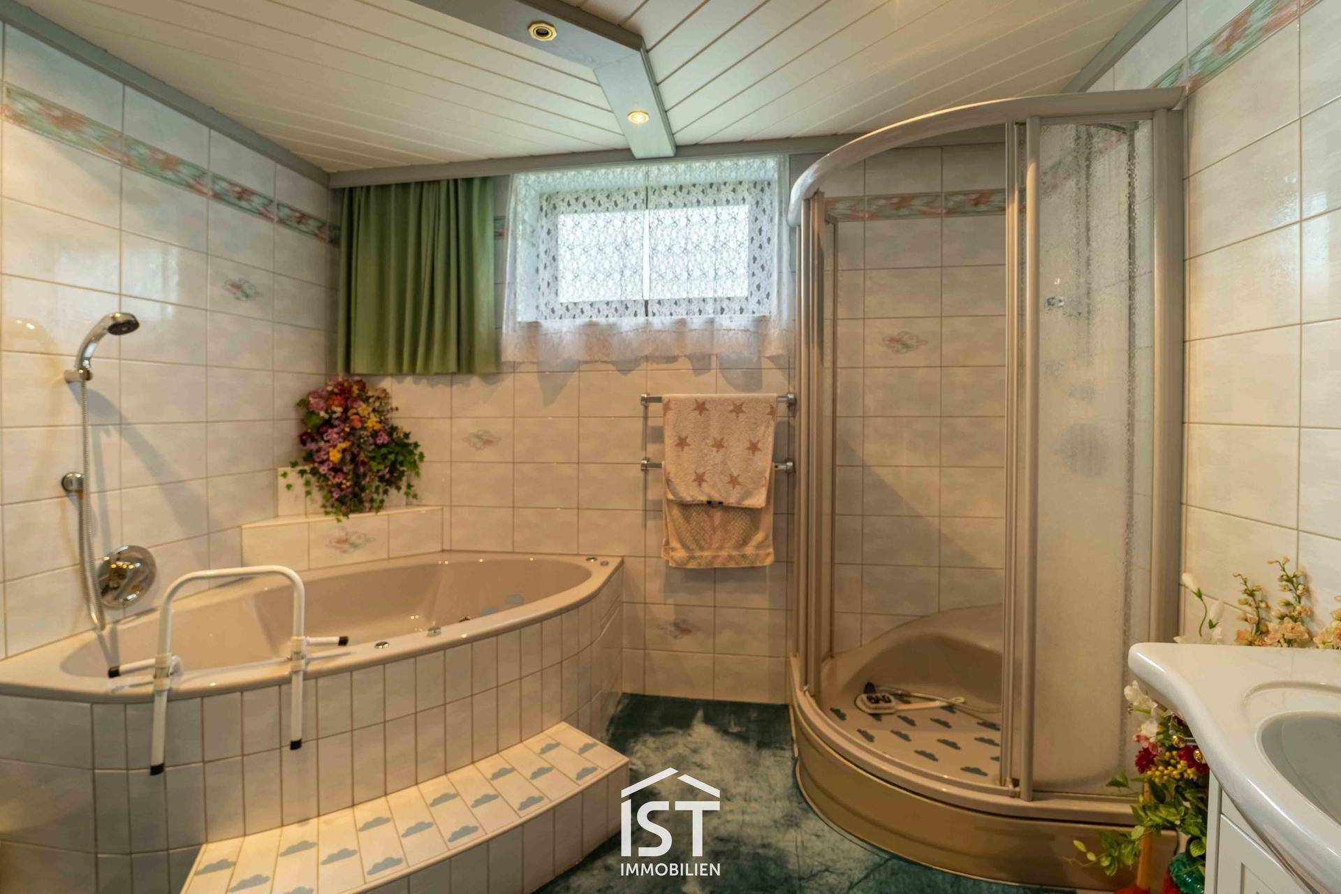 Geräumiges Badezimmer mit Eckbadewanne, Duschkabine und gefliesten Wänden.