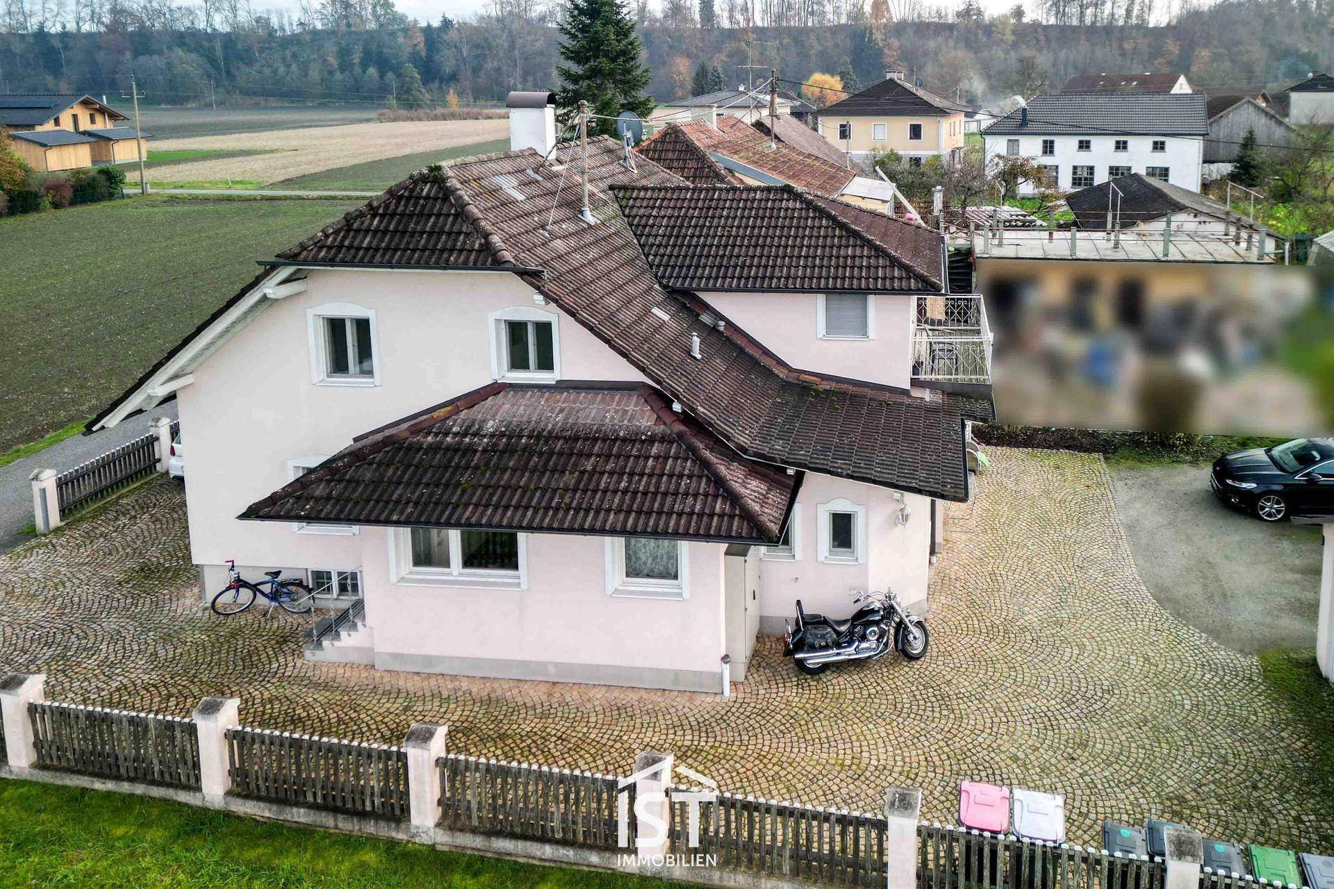 Rückansicht des Hauses mit Satteldach und Blick auf die umliegende Landschaft.