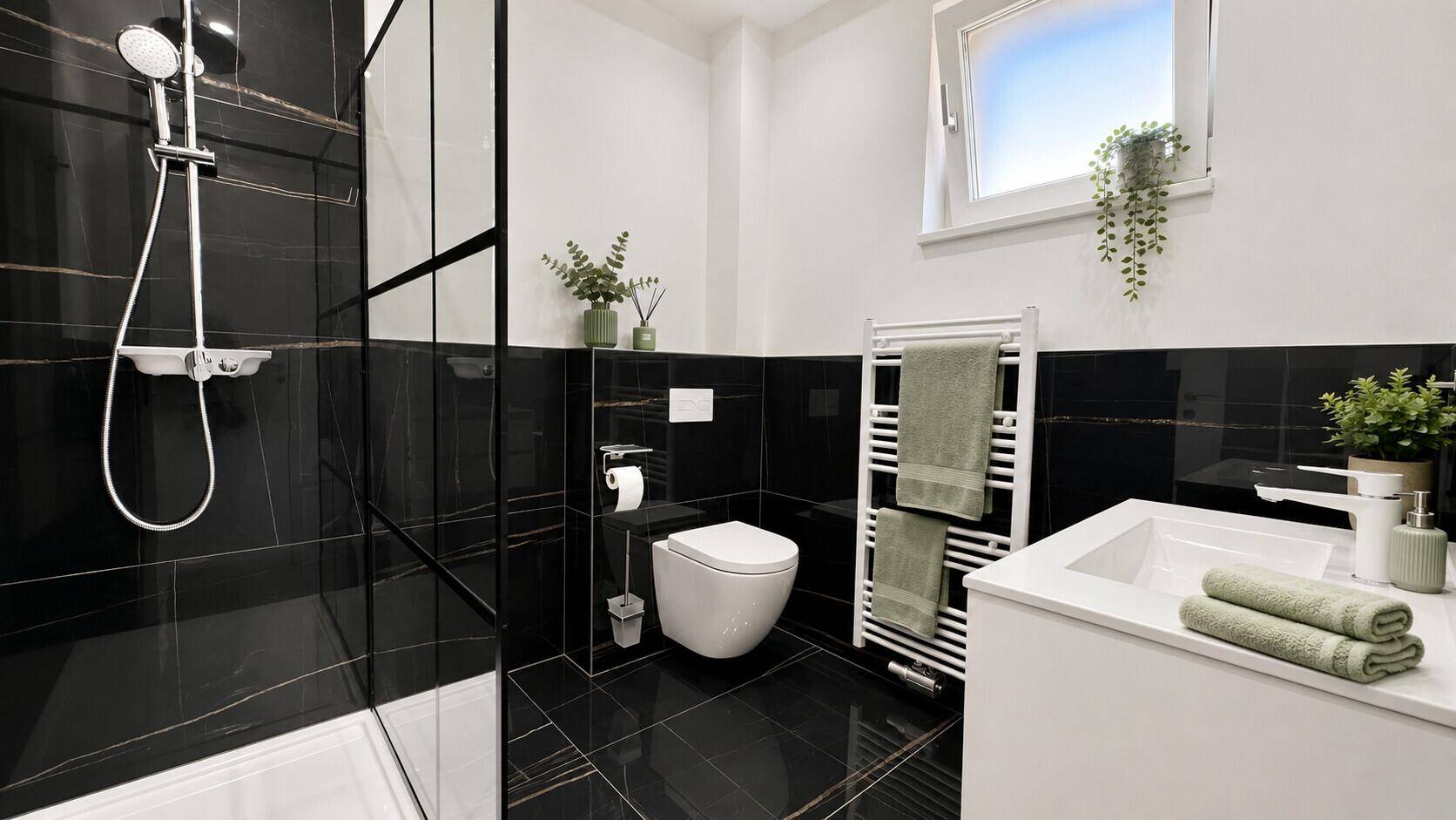 Modernes Badezimmer mit schwarzen Fliesen, Duschkabine, wandhängendem WC und Fenster für Tageslicht.