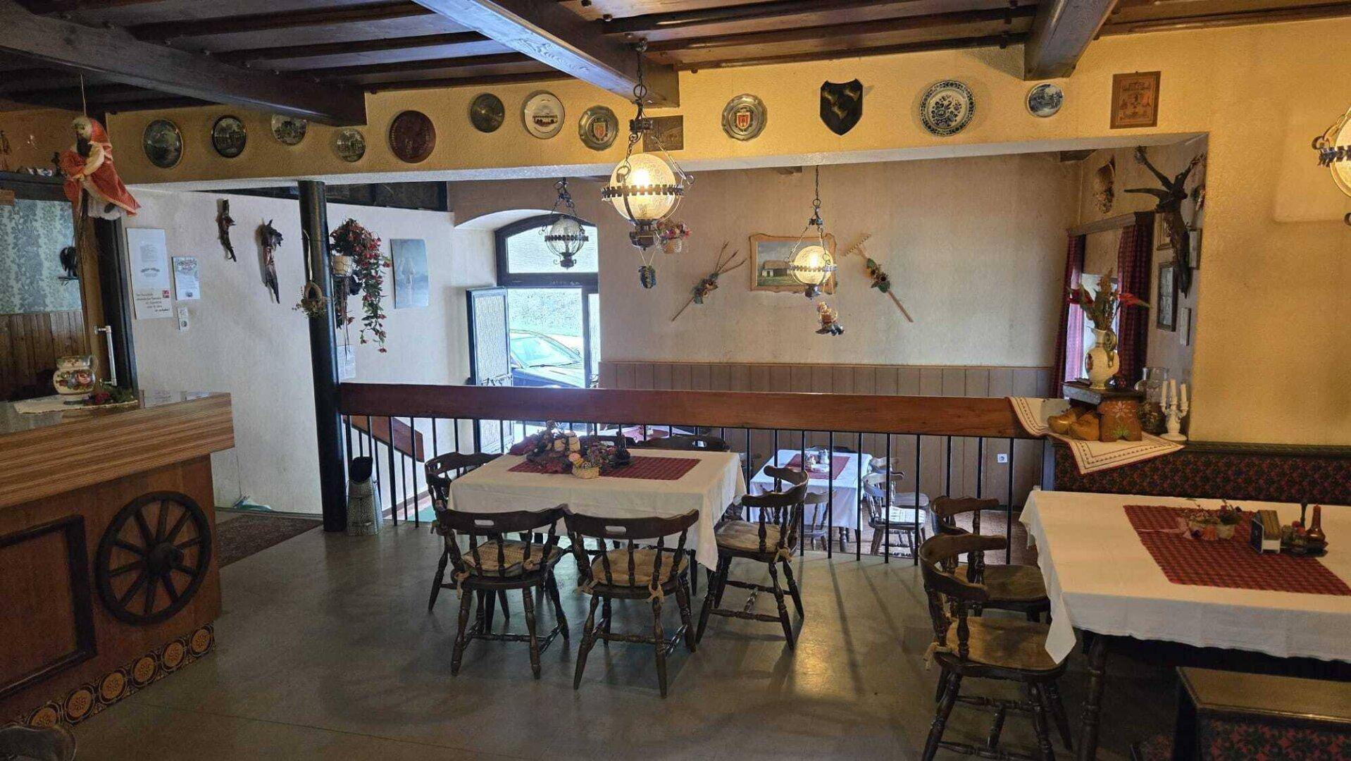 Gemütlicher Essbereich mit Holztischen und Stühlen, traditionell eingerichtet und dekoriert.