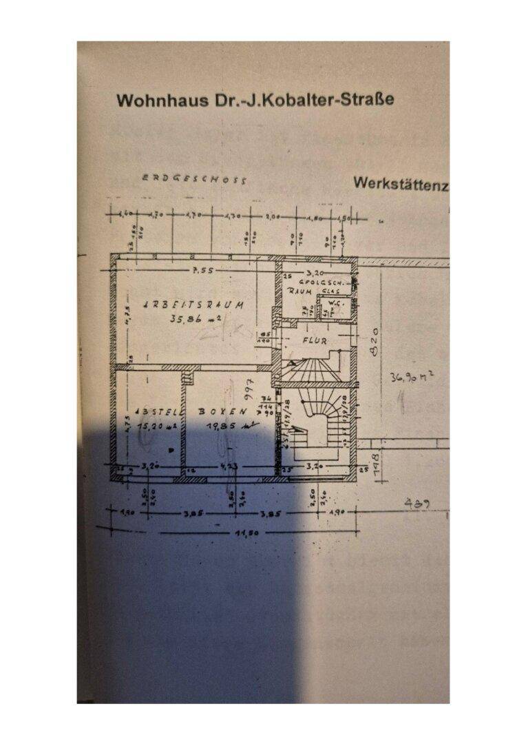 Grundriss des Erdgeschosses mit Arbeitsraum, Abstellraum und Flur, inklusive Treppenaufgang.