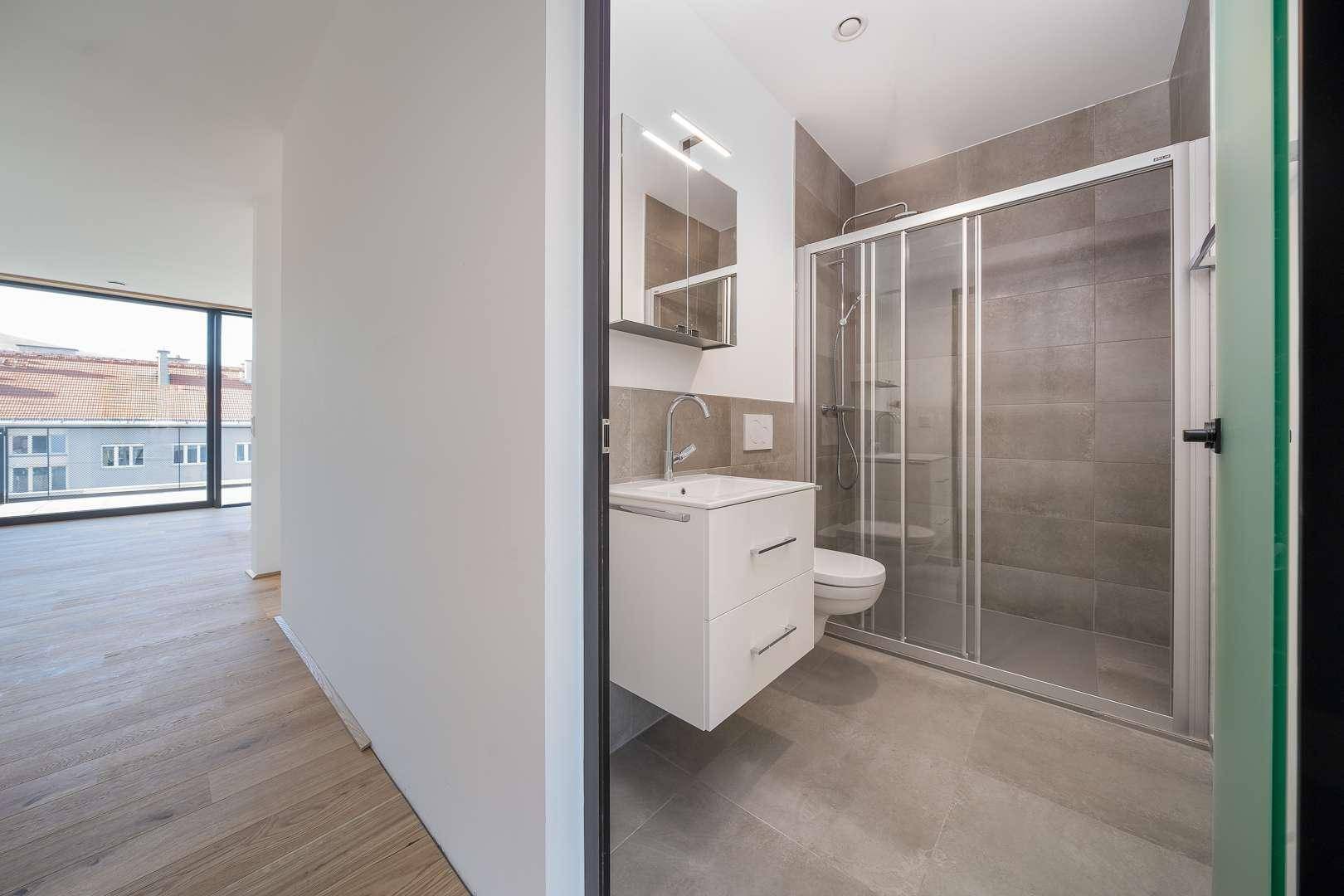 Kompaktes Badezimmer mit Dusche, Einzelwaschbecken und Spiegelschrank.